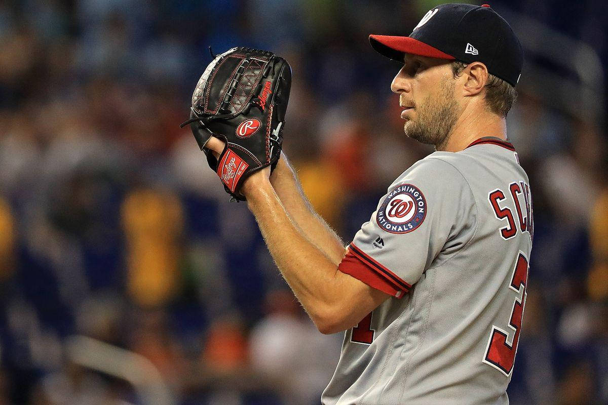 Max Scherzer 桌布 壁紙 — 一名身穿華盛頓國民隊球衣的棒球投手在明亮的燈光下於球場舉起手套。