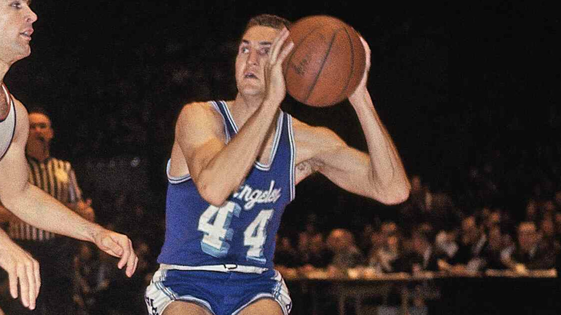 NBA 桌布 壁紙 — 一名身穿藍色球衣、背號44的籃球運動員準備投籃，防守球員在場館燈光下逼近。