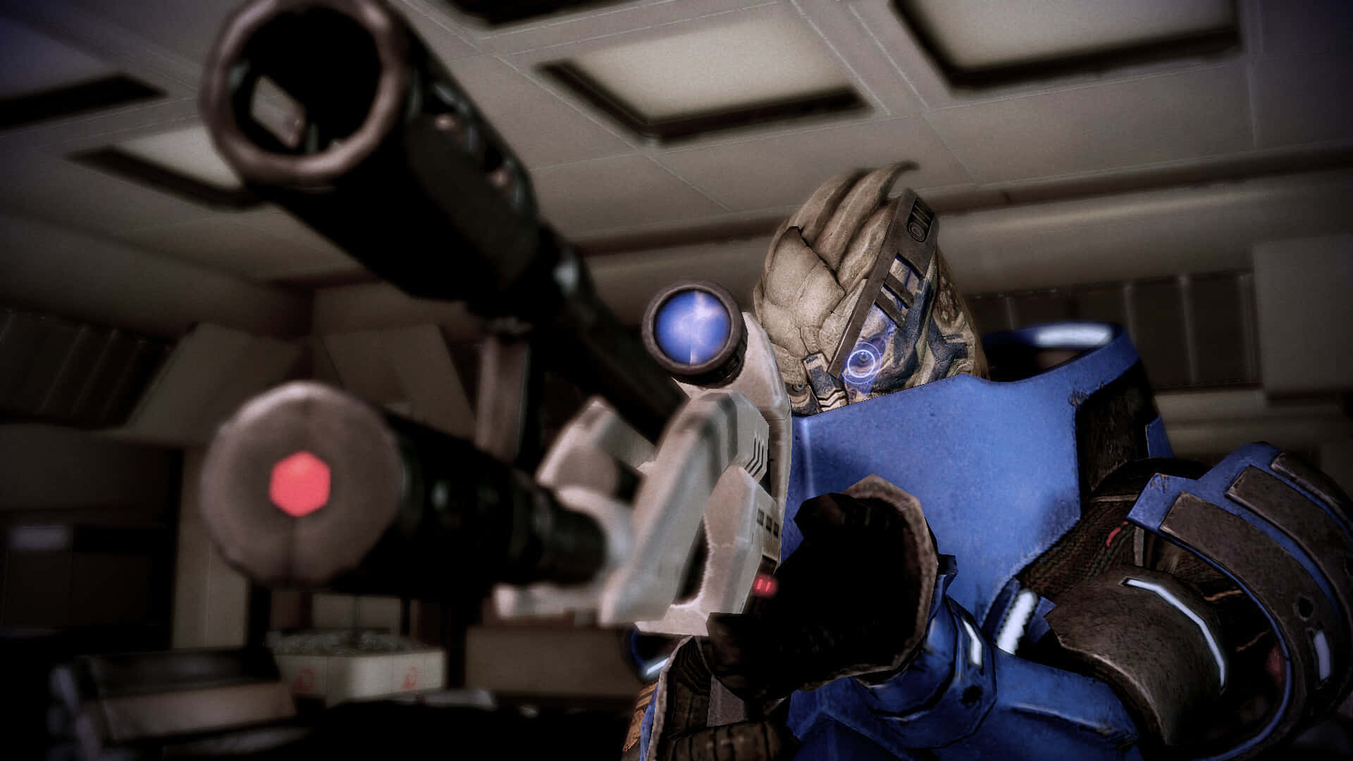 Garrus Vakarian 桌布 壁紙 — 一名身穿藍色裝甲的未來士兵在光線昏暗的太空船走廊中，瞄準一把帶有發光藍色和紅色瞄準器的重型武器。
