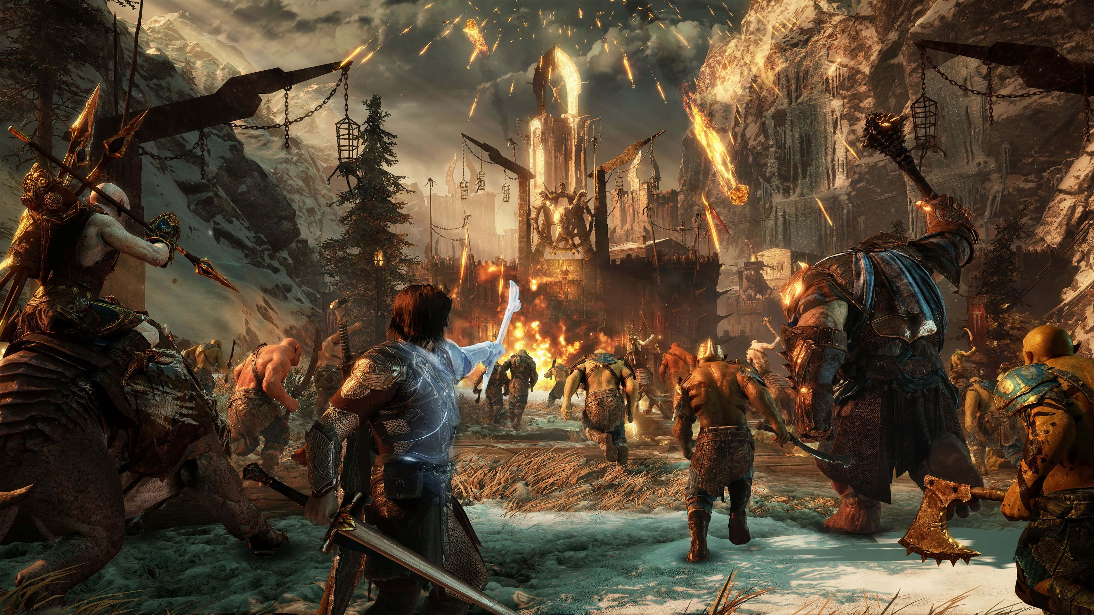 4K Shadow Of War 桌布 壁紙 — 一名身穿藍色長袍的戰士舉起發光的手，一支軍隊穿過白雪覆蓋的山口，衝向燃燒的堡壘。
