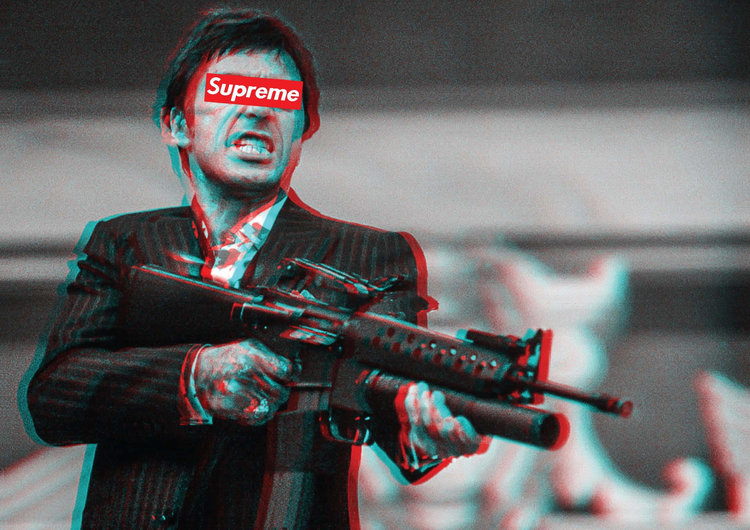 tony montana 桌布 壁紙 — 一名身穿西裝的男子手持步槍，帶有紅色和青色的立體3D效果，眼睛上方有Supreme標誌。