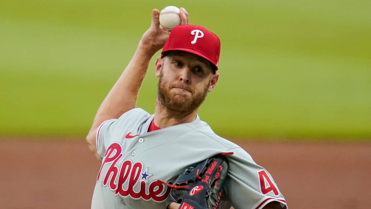 Phillies 桌布 壁紙 — 一名身穿費城人隊球衣的棒球投手在綠色球場上準備投球。