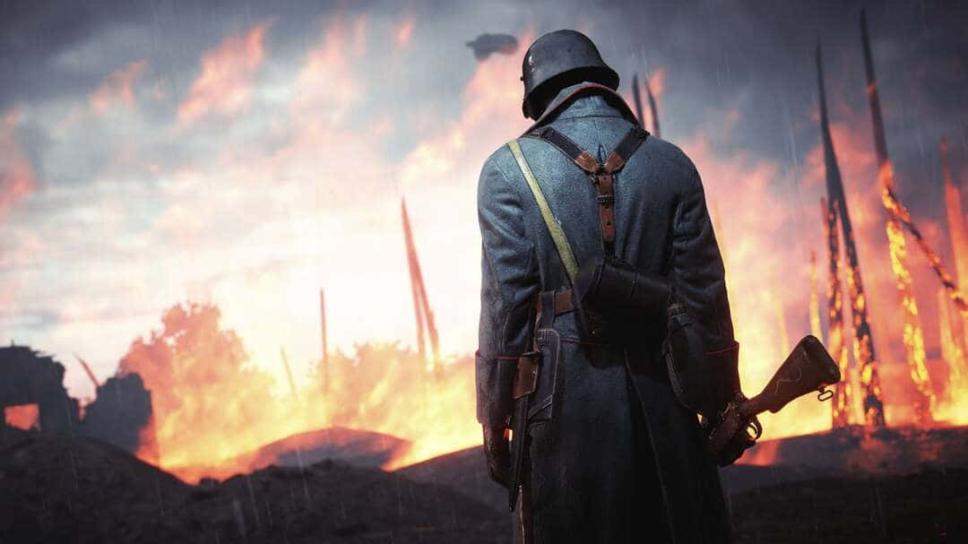 Battlefield 桌布 壁紙 — 一名身穿軍服的士兵，在戰火摧殘的戰場上，背對著熾熱的爆炸和雨水站立。