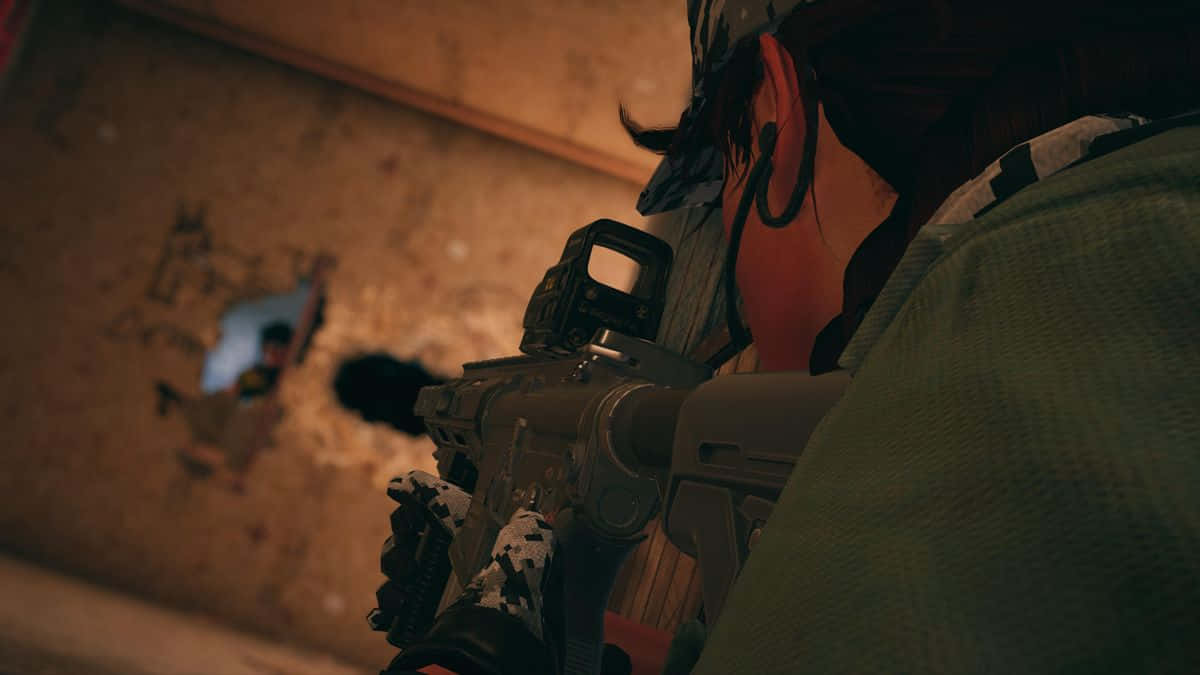 Rainbow Six Siege Ash 桌布 壁紙 — 一名身穿迷彩服的士兵在光線昏暗的城市戰鬥區域中，透過佈滿彈孔的牆壁瞄準步槍。