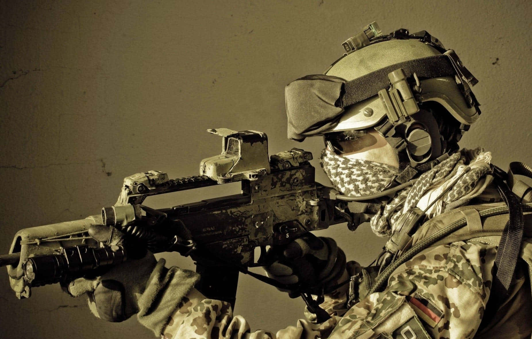 軍事動圖 桌布 壁紙 — 一名身穿迷彩裝備和頭盔的士兵，對著一面柔和的米色牆壁，專注地瞄準步槍。