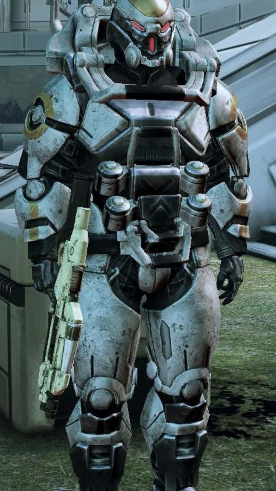 Mass Effect Cerberus 桌布 壁紙 — 一名身穿重型裝甲、擁有發光紅眼的未來士兵，站在骯髒的城市環境中手持武器。