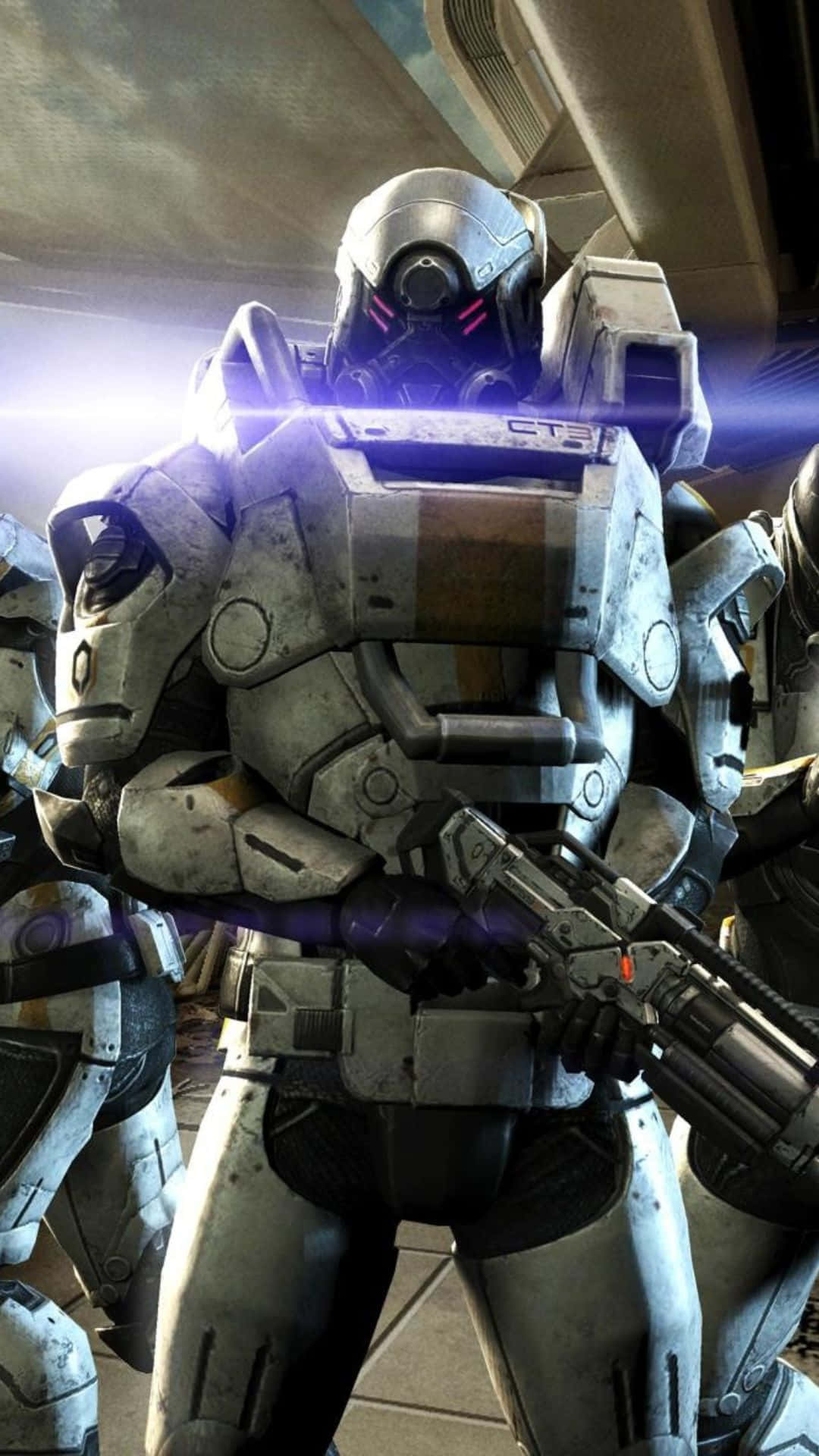 Mass Effect Cerberus 桌布 壁紙 — 一名身穿重型裝甲的士兵，配備未來戰鬥裝備，在昏暗的科幻走廊中手持發光武器準備就緒。
