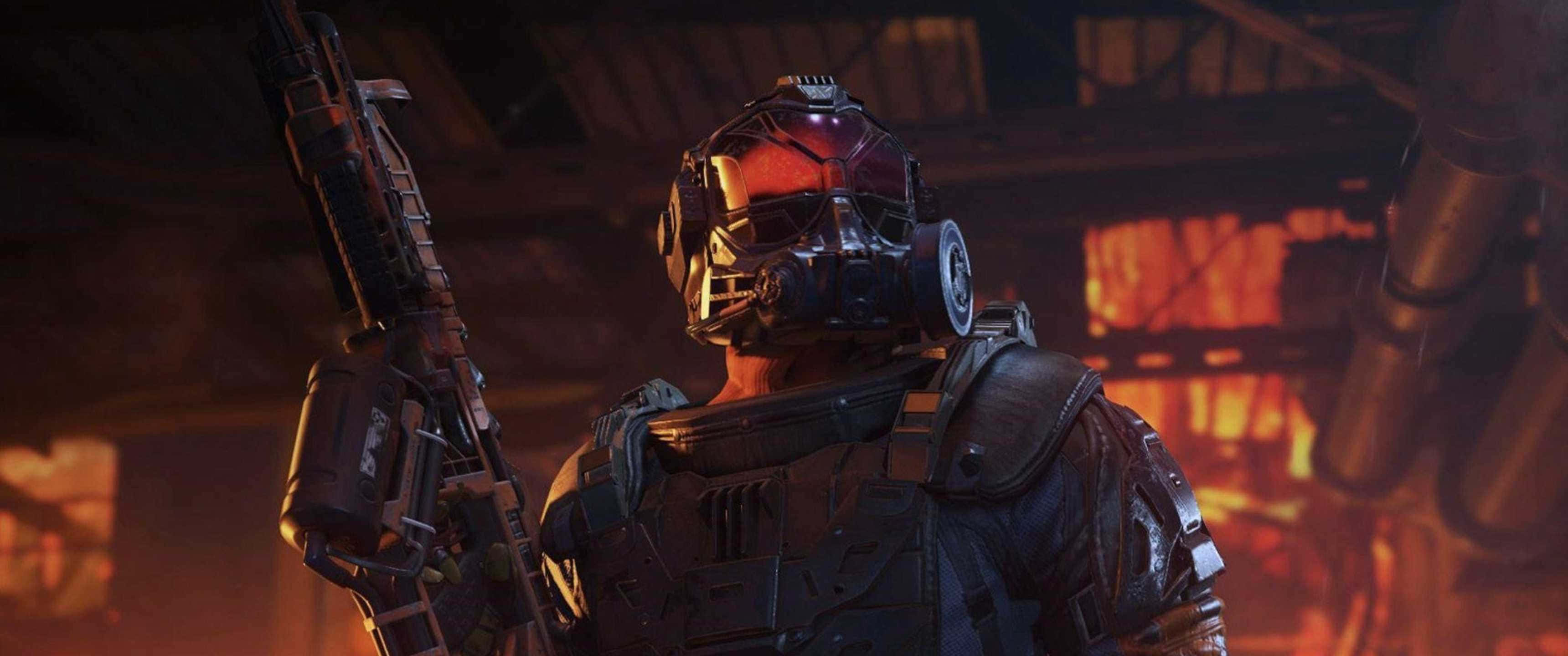 3440x1440p Call Of Duty Black Ops 4 桌布 壁紙 — 一名身穿重甲、戴著發光紅色面罩的士兵，站在昏暗的工業廢墟中，手持未來步槍。