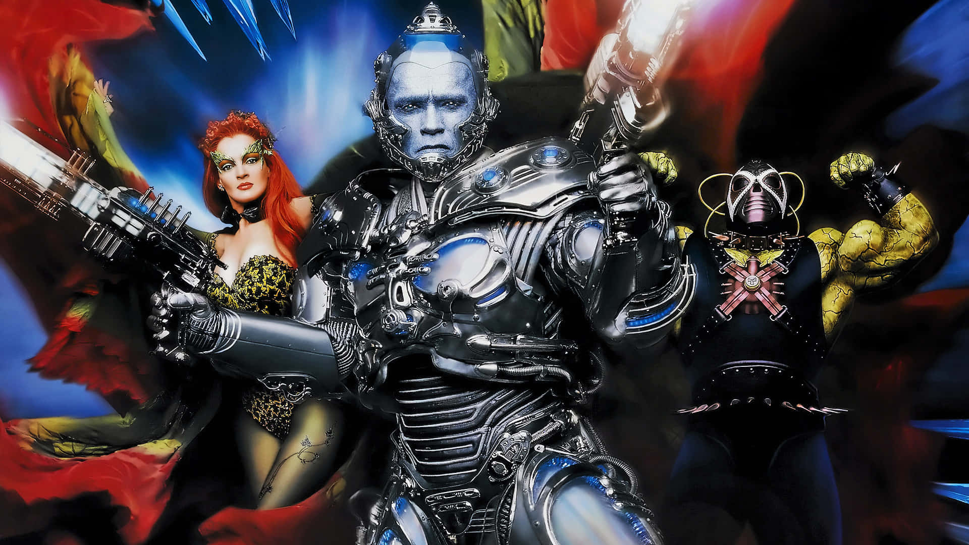 Mr Freeze 桌布 壁紙 — 一名身穿閃亮銀色盔甲的機械戰士，與紅髮蛇蠍美人及肌肉發達的惡棍，以動感科幻動作姿勢站在舞台中央。