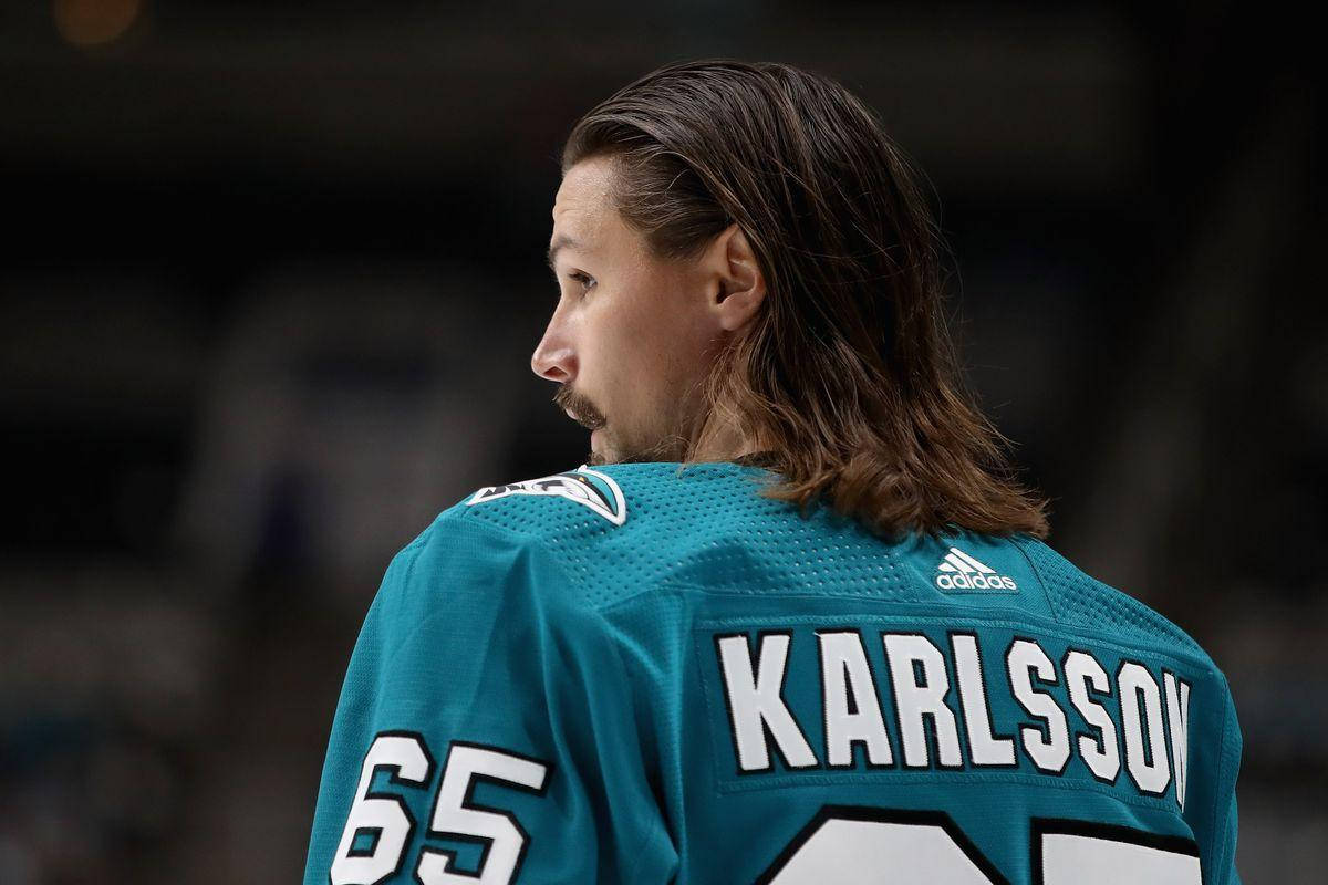 運動 桌布 壁紙 — 一名身穿青綠色球衣、背後印有「KARLSSON」和65號的冰球運動員，越過肩膀回望的特寫。