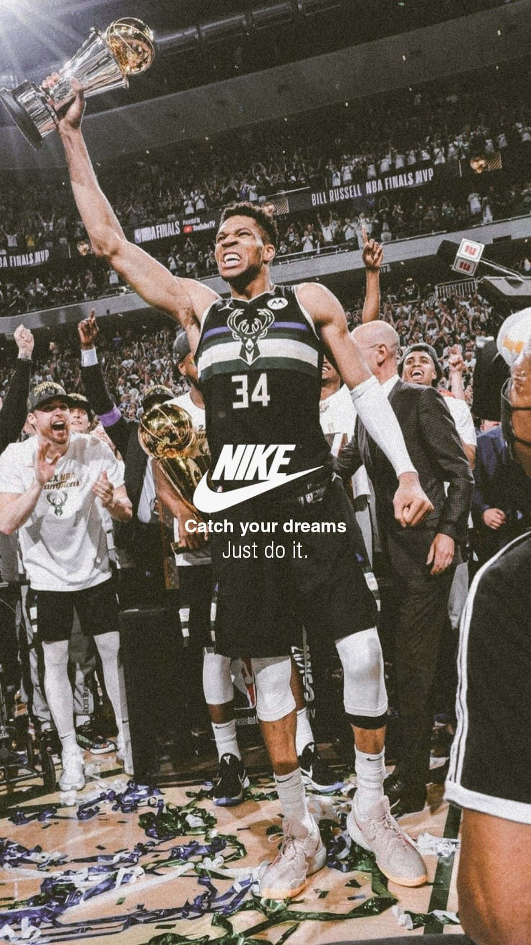 Nike 節奏籃球 桌布 壁紙 — 一名身穿黑色34號球衣的籃球運動員在佈滿五彩碎紙的球場上高舉冠軍獎盃，慶祝勝利。