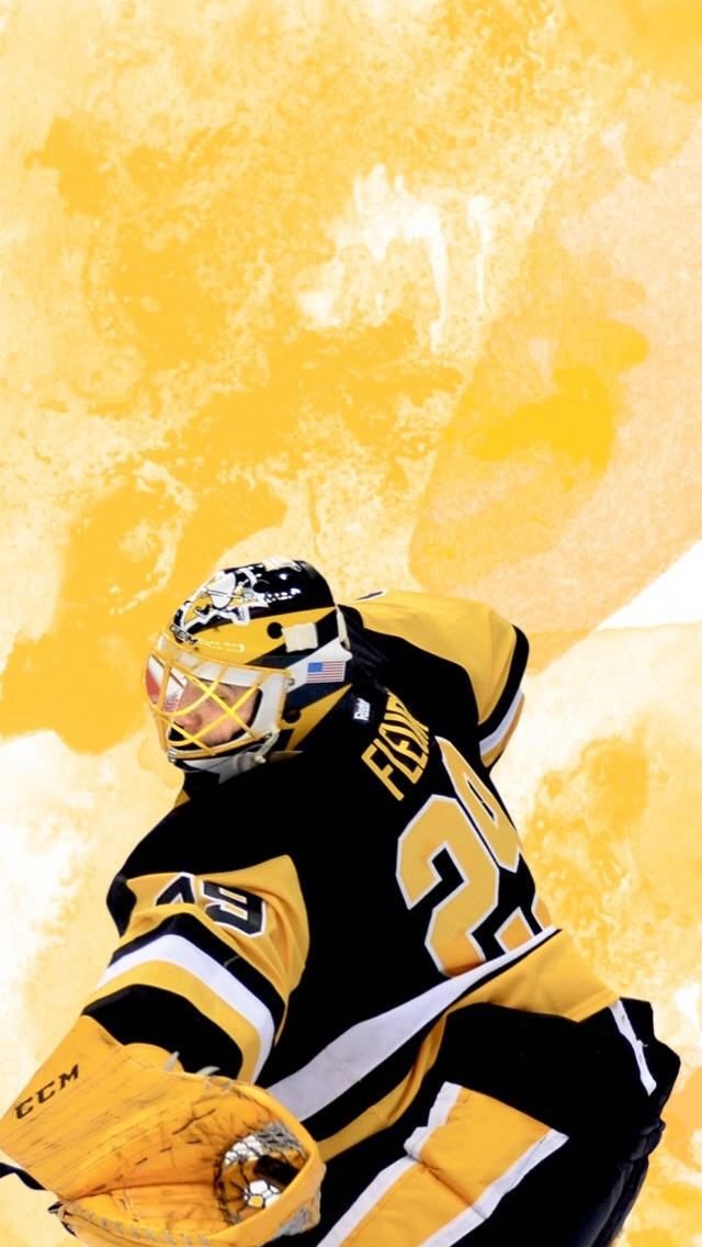 hockey 桌布 壁紙 — 一名身穿黑色和金色裝備的冰球守門員，在帶有紋理的金色背景前動態蹲下。