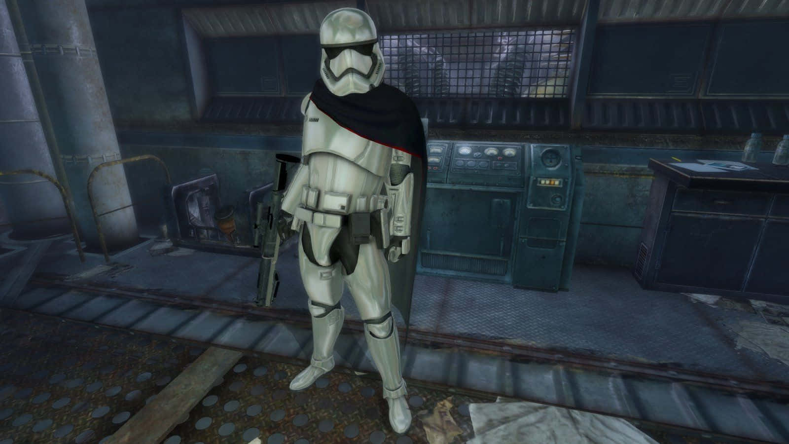 Captain Phasma 桌布 壁紙 — 一名身穿黑色斗篷的風暴兵在昏暗的工業房間內警覺地站立，房間內有控制面板和金屬牆壁。