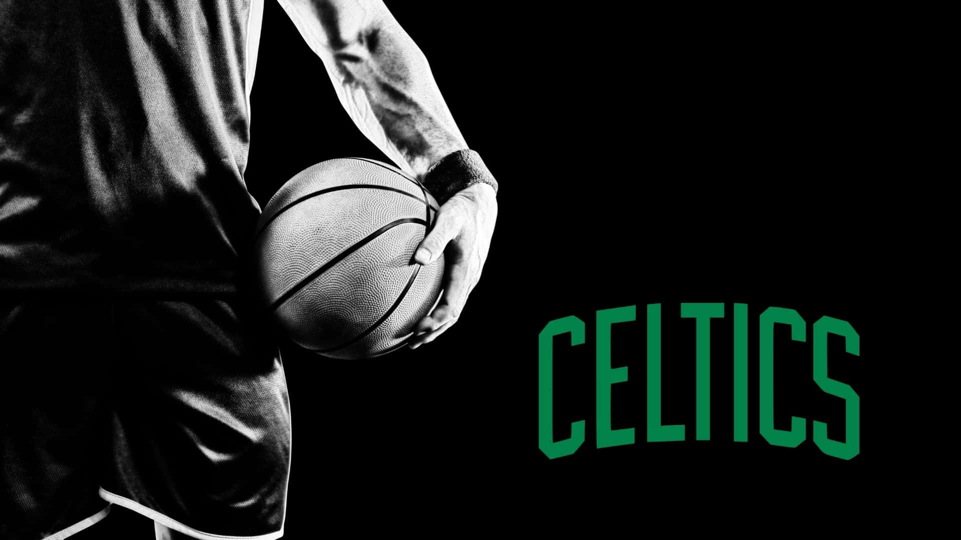 Celtics 桌布 壁紙 — 一名身穿黑色球衣的籃球運動員在黑色背景前持球，背景上有綠色 'CELTICS' 字樣。