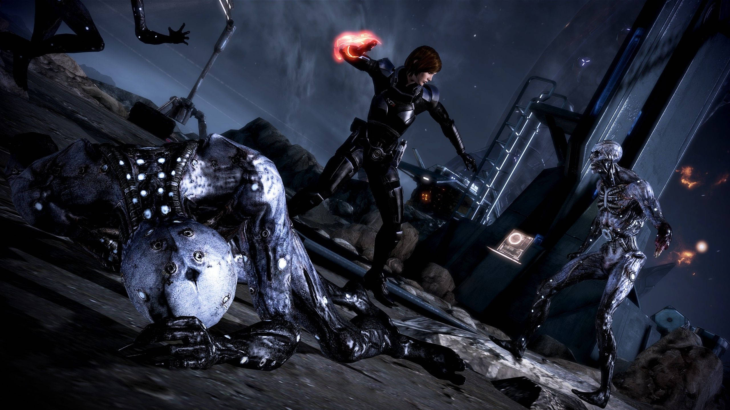 Mass Effect 3 桌布 壁紙 — 一名身穿黑色盔甲的戰士在黑暗的科幻廢墟中，站在一個倒下的外星生物上方，引導紅色能量。