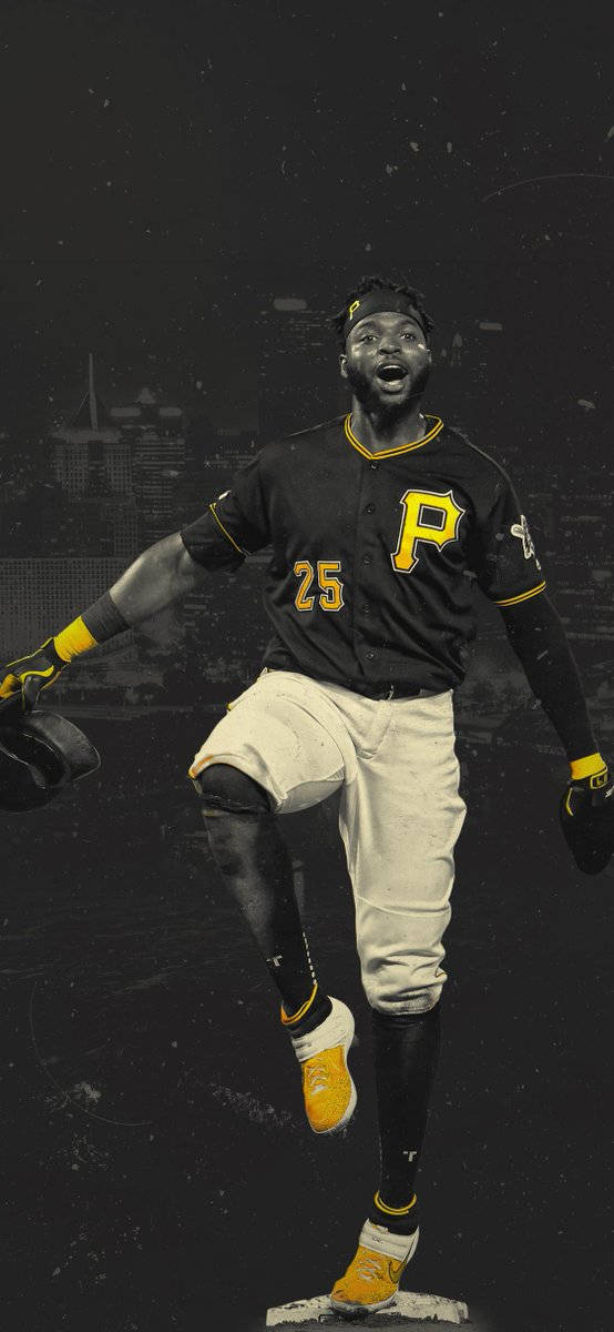 Pittsburgh Pirates 桌布 壁紙 — 一名身穿黑黃色球衣的棒球選手在黑暗的城市天際線背景下，在本壘板上勝利地跳躍。