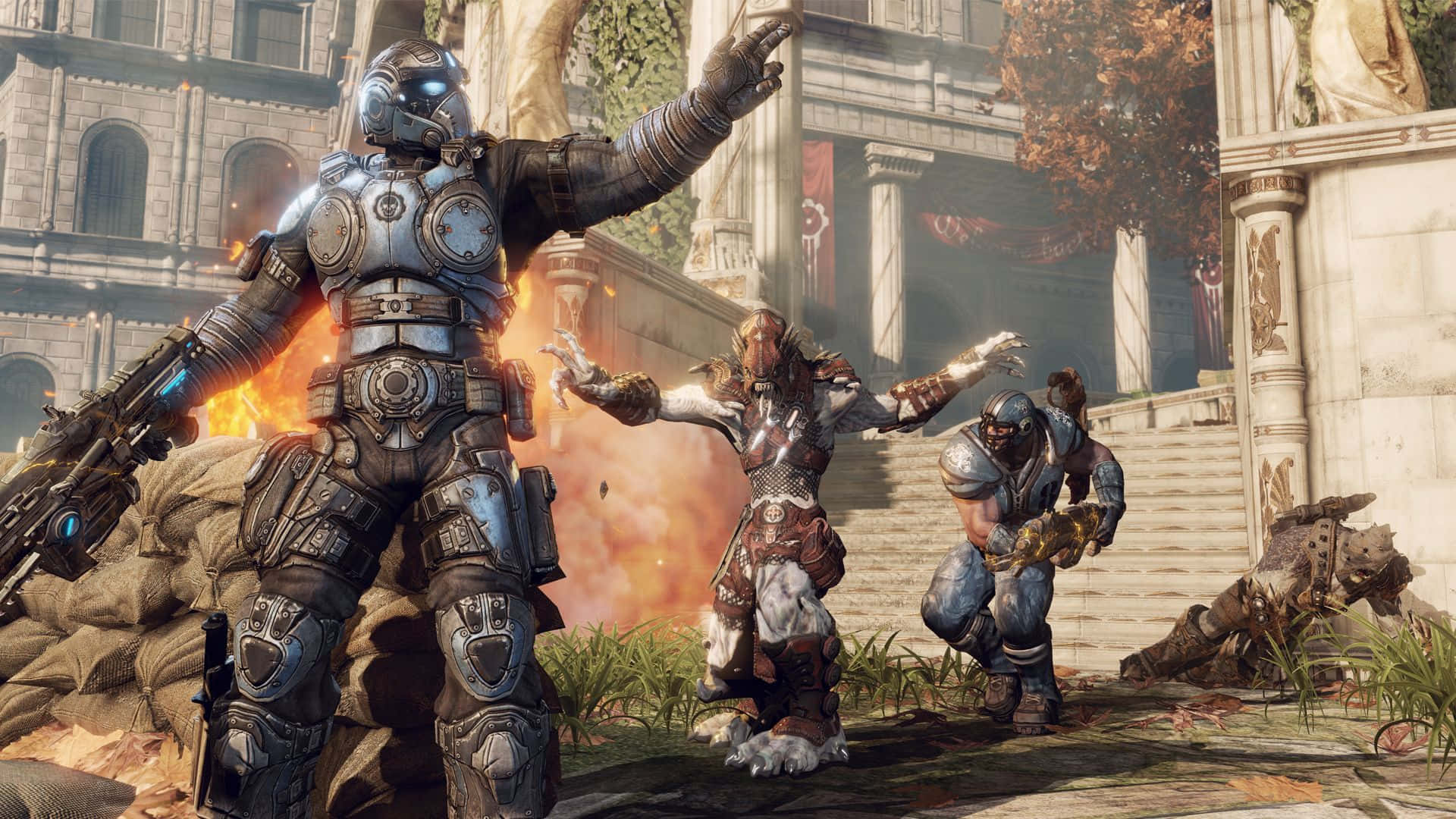 Best Gears Of War 5 桌布 壁紙 — 一名重裝甲士兵在熾熱爆炸中挑釁地站立，而盟友們在廢墟的古典廣場上與怪物般的敵人戰鬥。