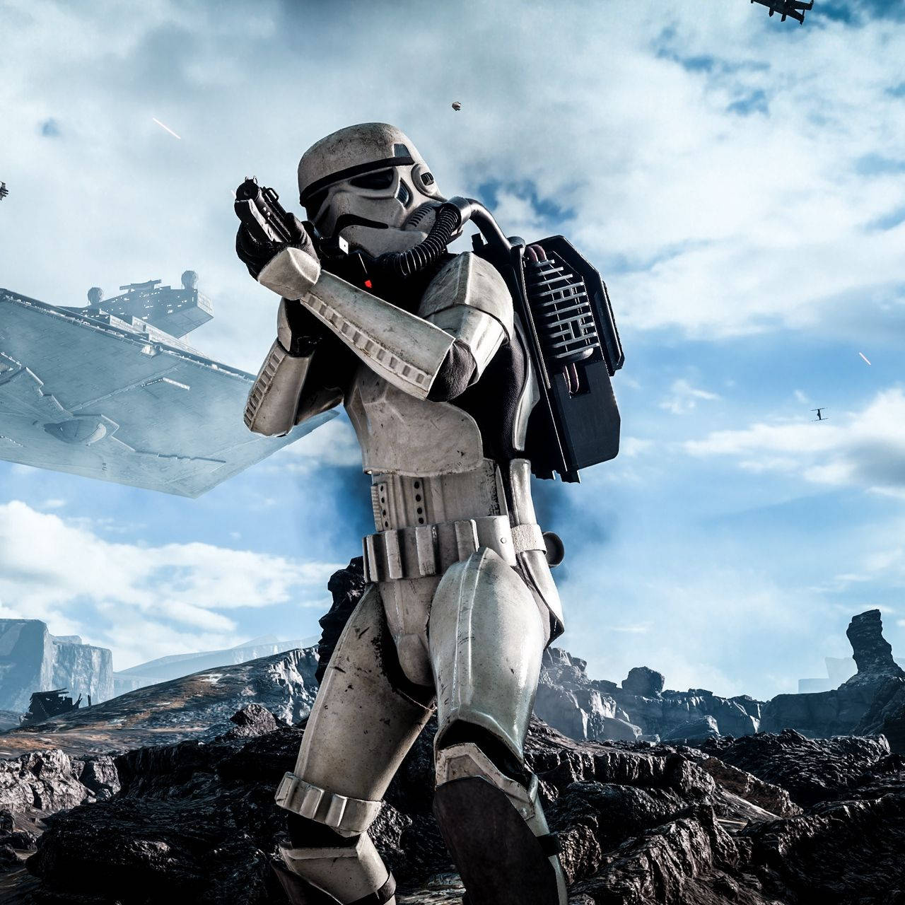 Stormtrooper 桌布 壁紙 — 一名風暴兵在岩石星球上準備就緒，星際戰機在陰雲密布的天空中飛過。