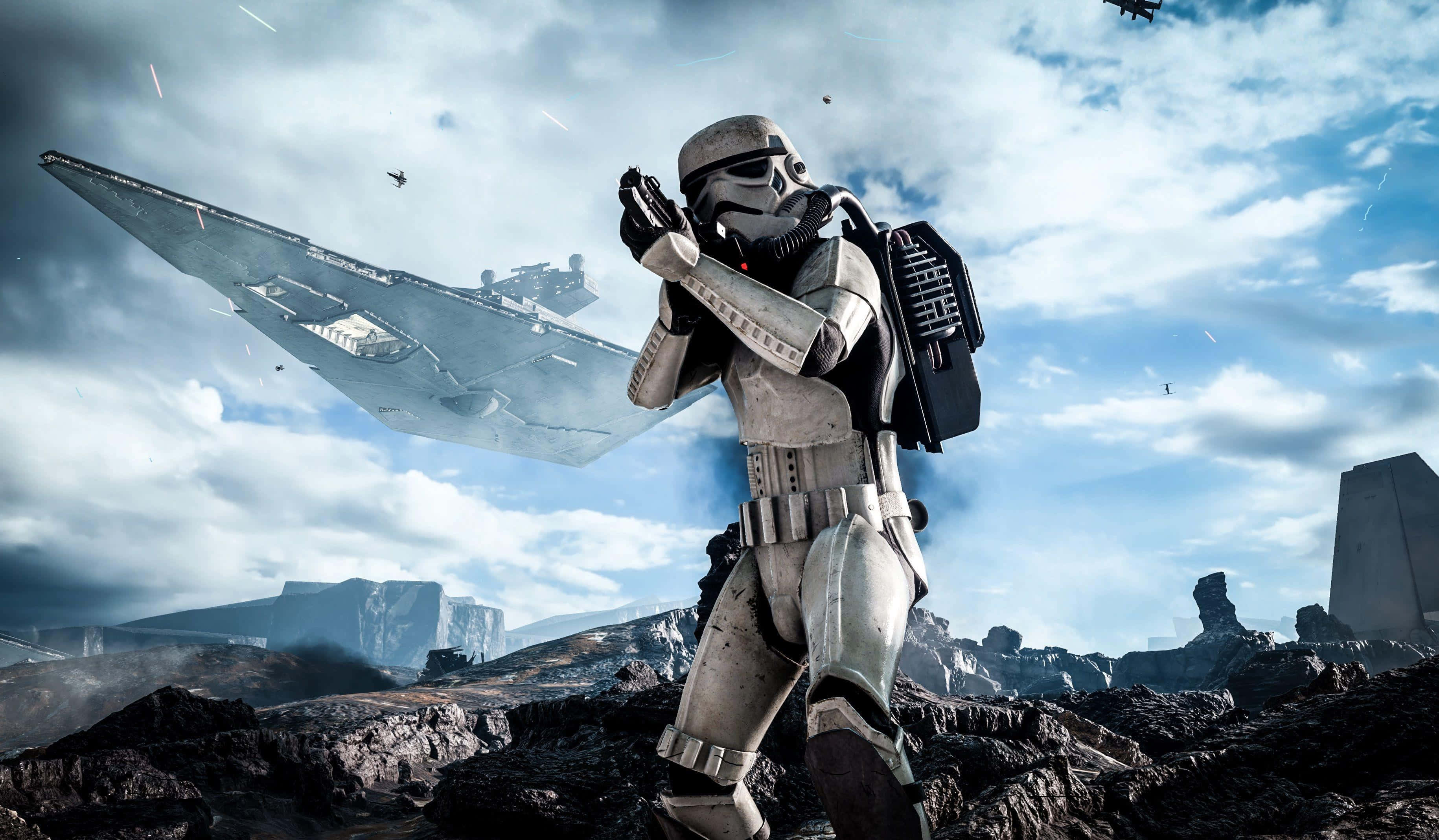 Scarif 桌布 壁紙 — 一名風暴兵站在岩石星球上，星際毀滅者號在陰雲密布的天空下飛過頭頂。