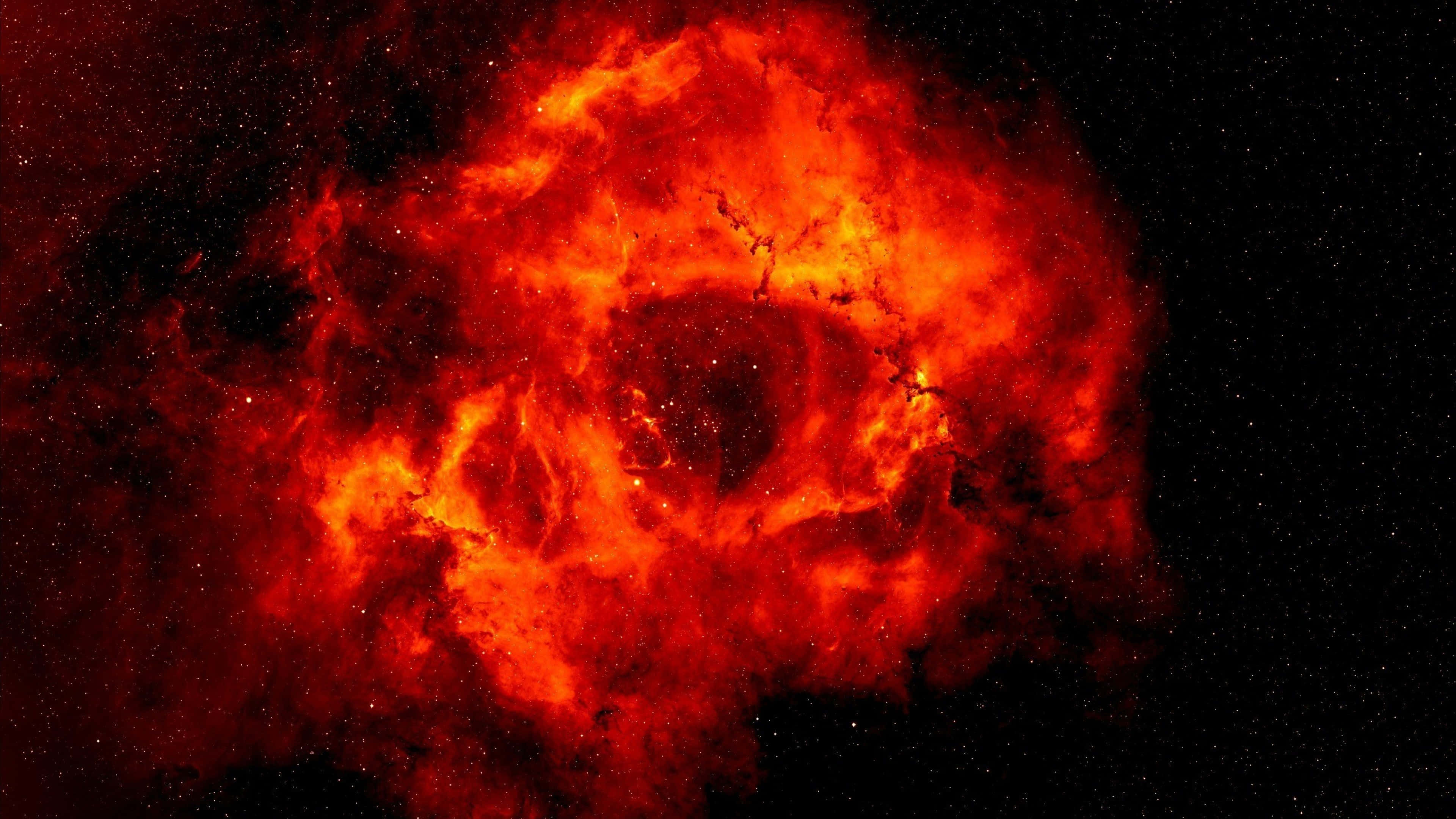 紅色動圖 桌布 壁紙 — 一團火紅色的星雲在佈滿星星的黑色宇宙虛空中戲劇性地旋轉。