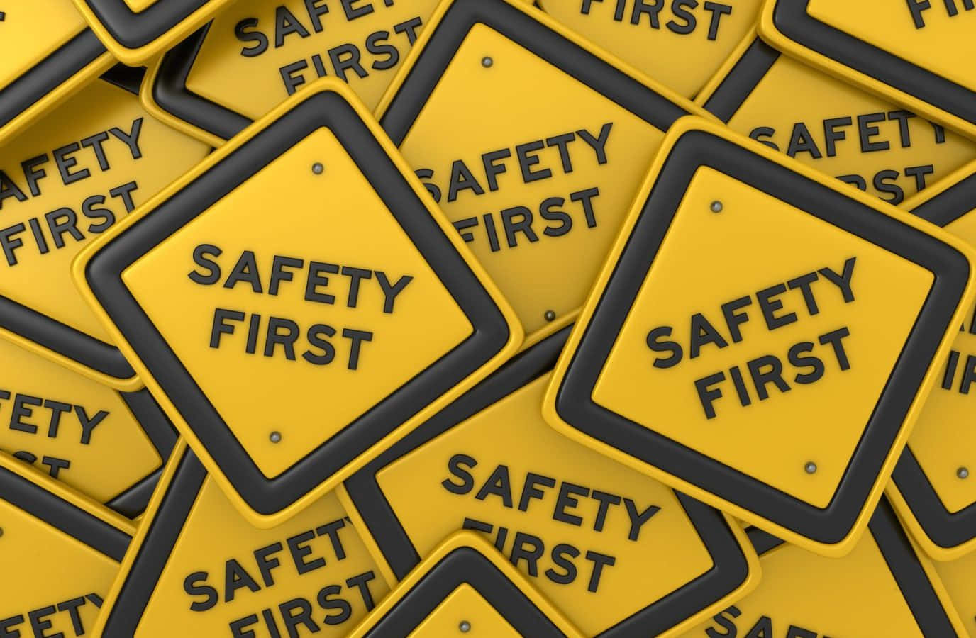 Safety 桌布 壁紙 — 一堆密集的亮黃色菱形標誌，上面有粗體黑色文字寫著 safety first。