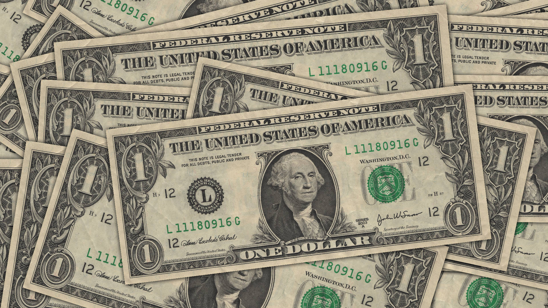 Money 桌布 壁紙 — 一堆混亂重疊的一美元鈔票，突出顯示喬治·華盛頓的肖像和綠色印章。