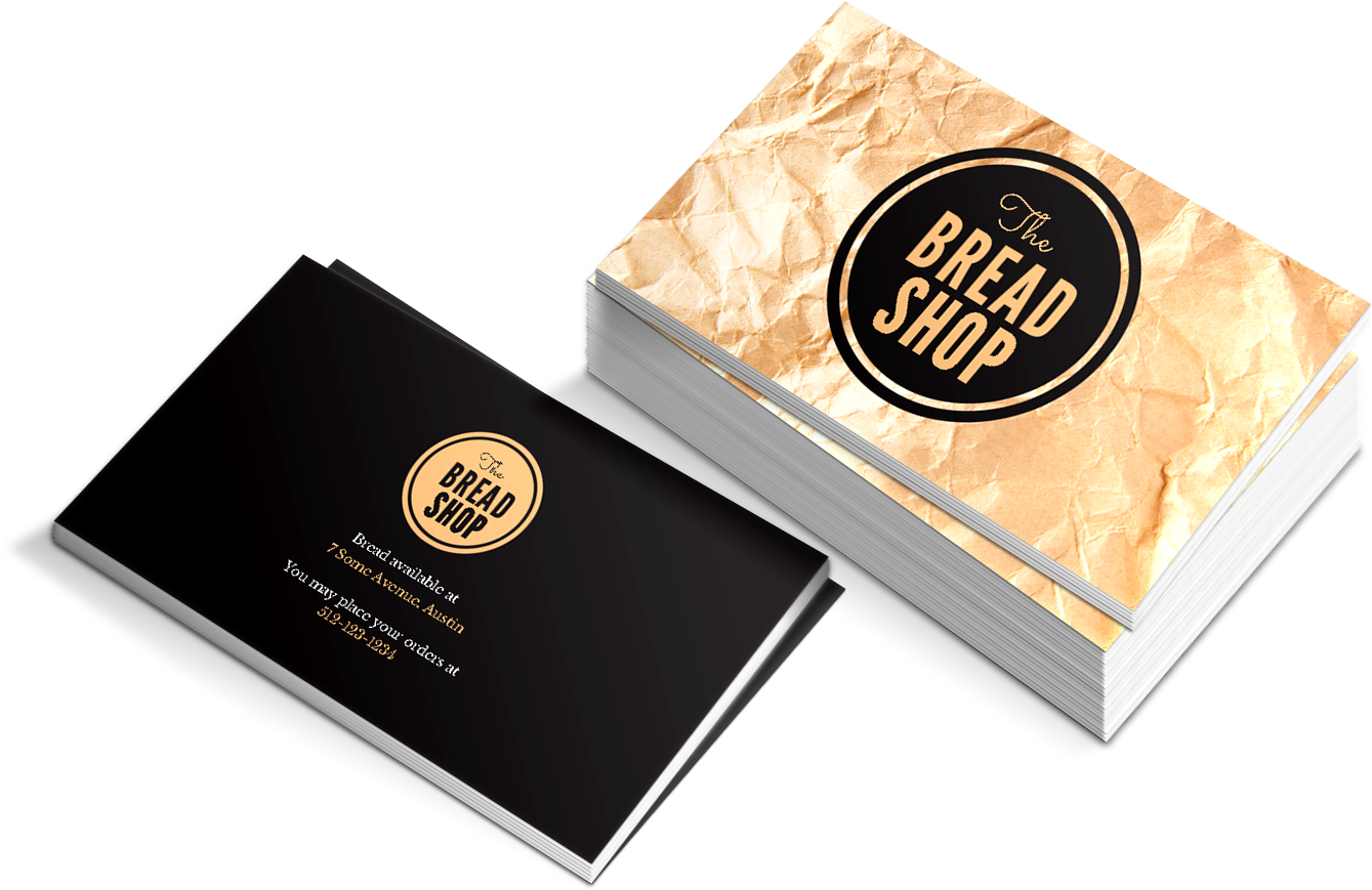 商業 桌布 壁紙 — 一堆皺紋金色名片，用於 The Bread Shop，黑色背面和金色標誌，黑色背景。