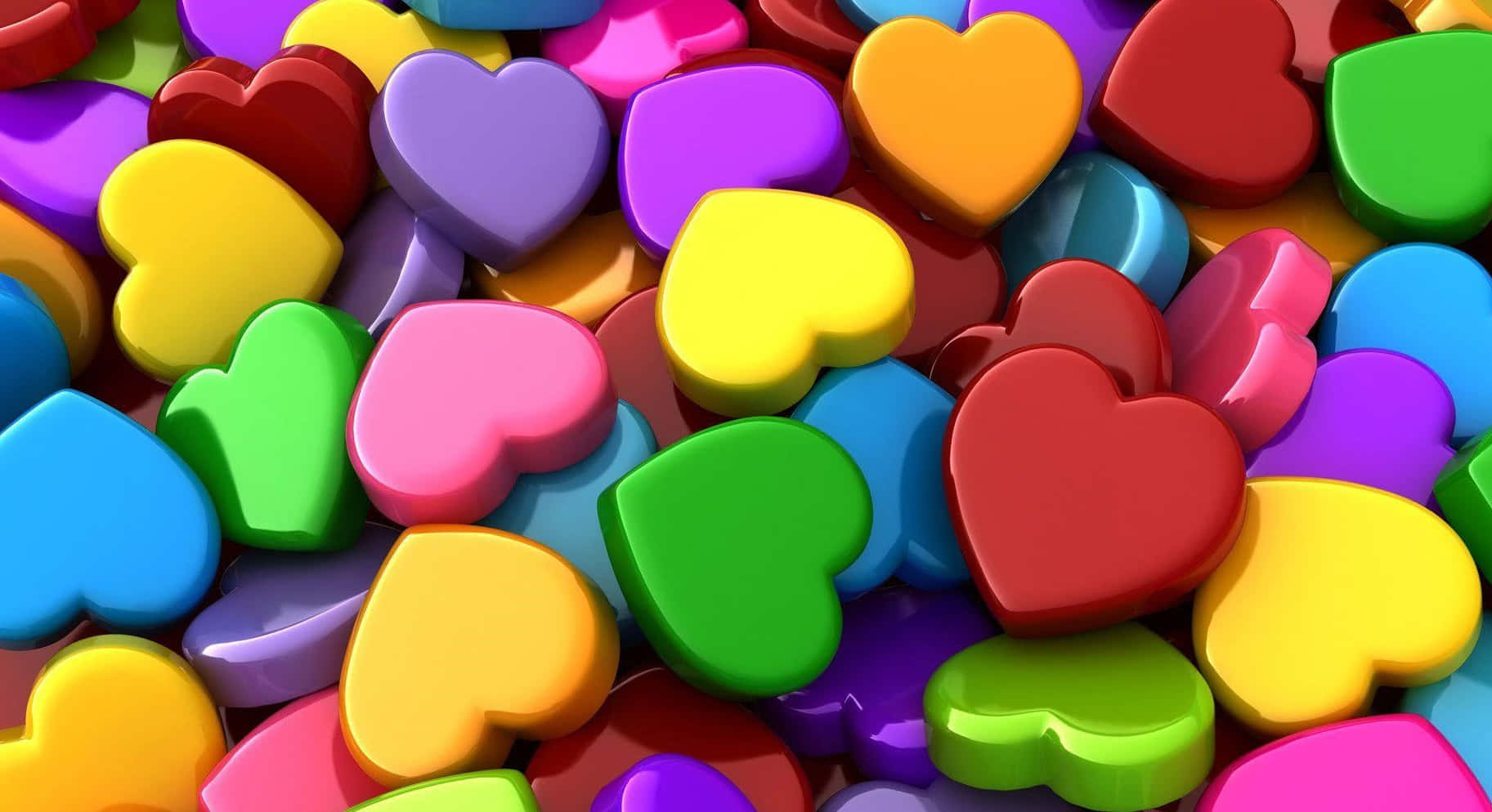 3d Heart 桌布 壁紙 — 一堆色彩繽紛、閃亮的心形糖果，以3D渲染，呈現明亮的彩虹色調。