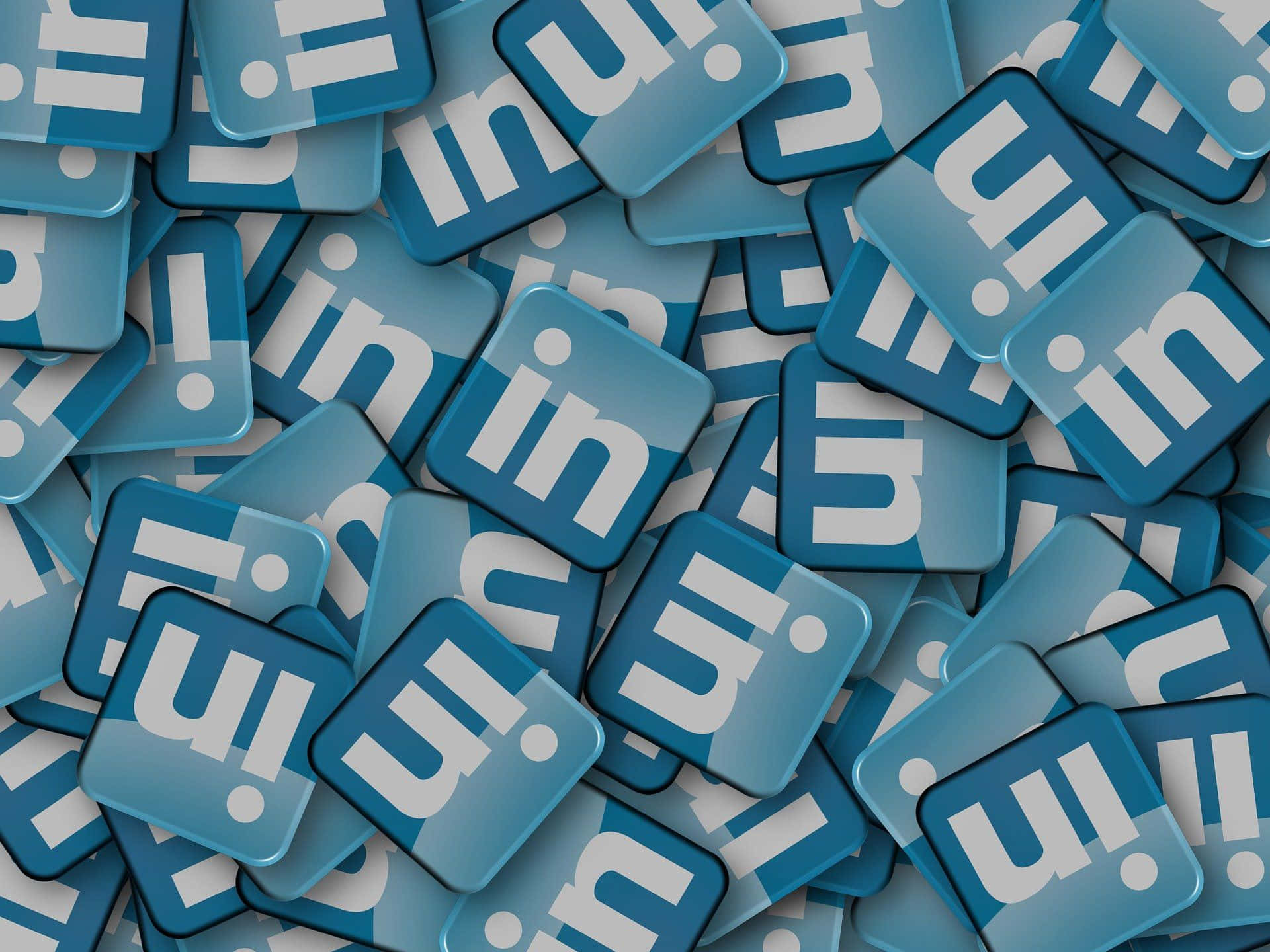 一堆帶有白色標誌的藍色LinkedIn應用程式圖示。 — Valorant Logo 壁紙