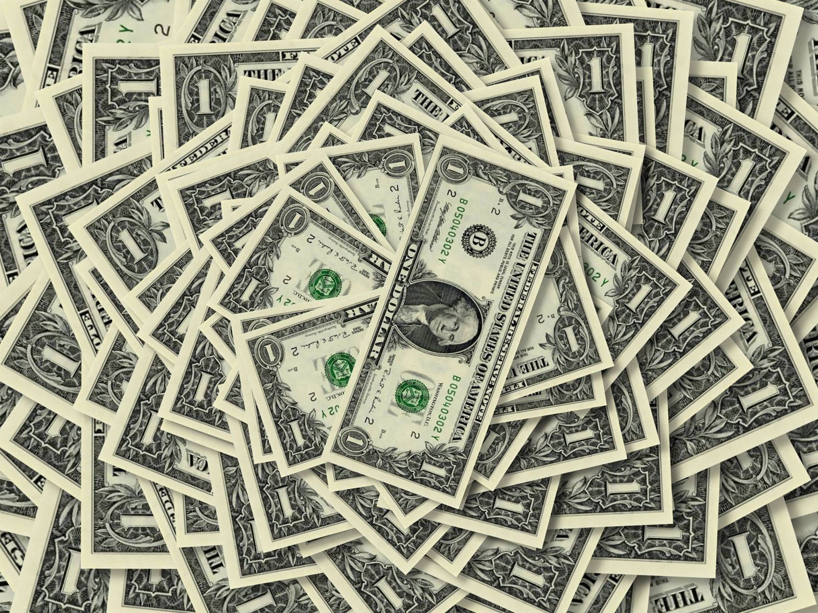No Money 桌布 壁紙 — 一堆重疊的一美元鈔票形成了一個帶有綠色和奶油色調的紋理化金融背景。