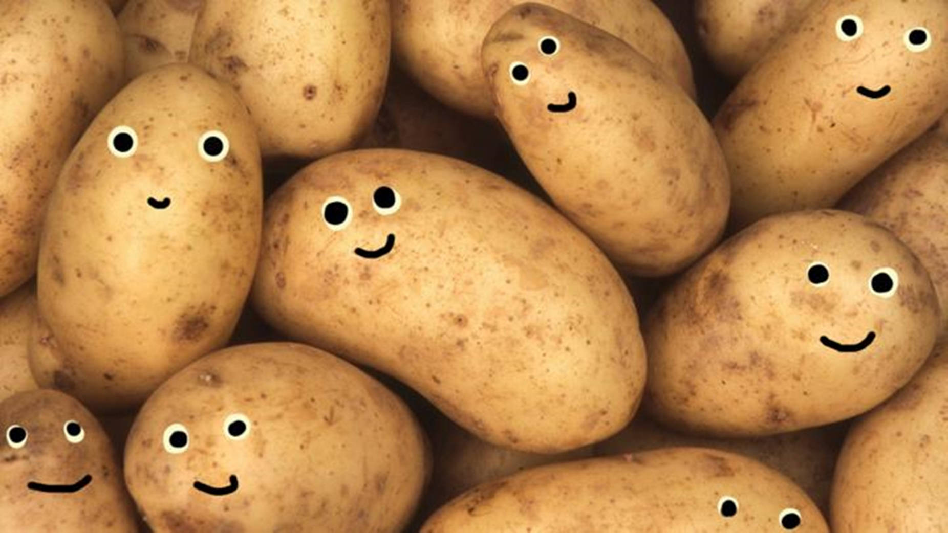 Potato 桌布 壁紙 — 一堆開心的馬鈴薯，帶有手繪的笑臉和眼睛。