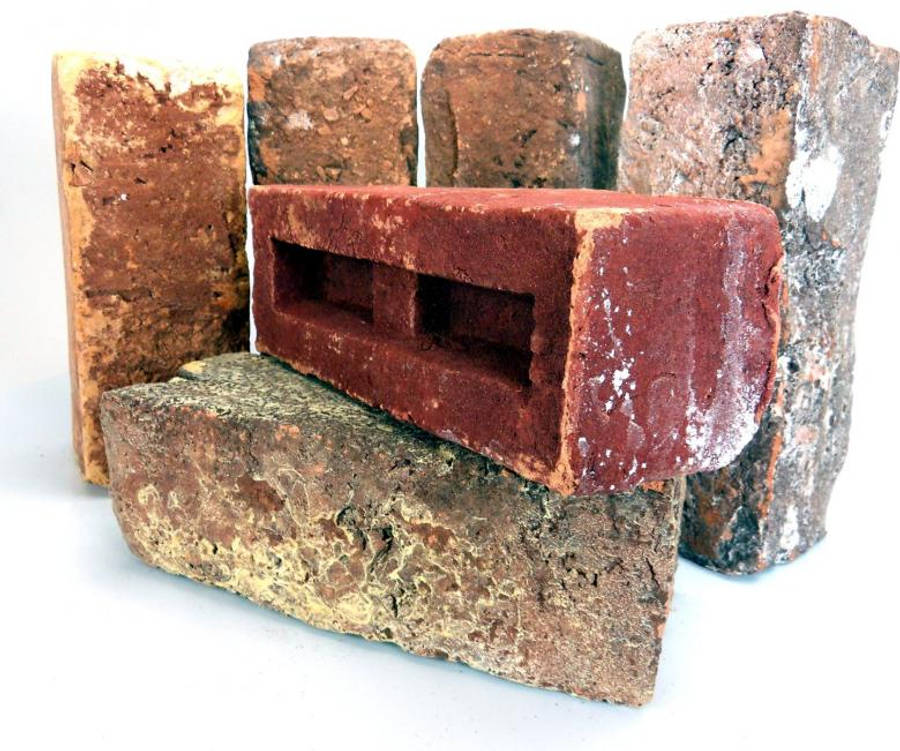 material desktop 桌布 壁紙 — 一堆風化磚塊，呈現多種大地色調，排列在純白背景上。