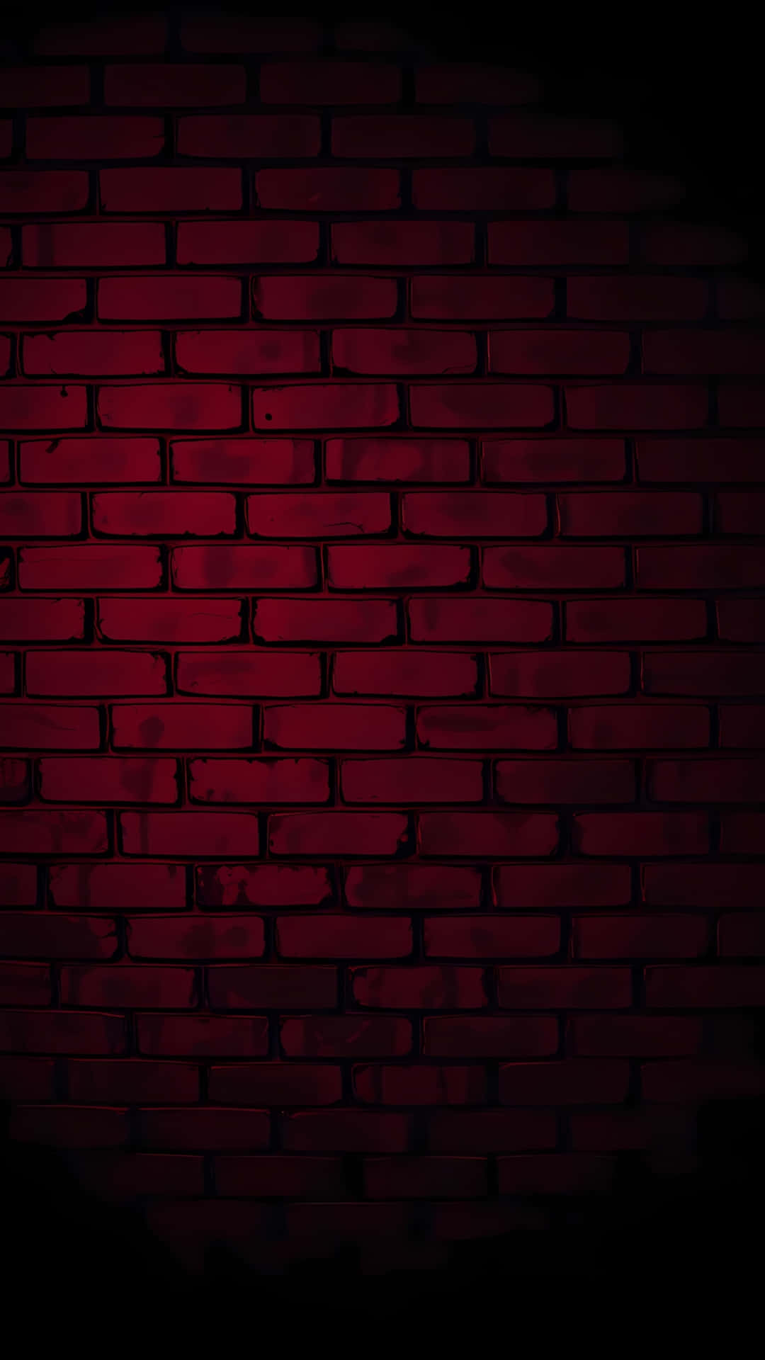 Dark Red Grunge Brick Wall Texture 壁紙 — 一堵昏暗的磚牆，沐浴在深紅色的光線中，邊緣有暗影。