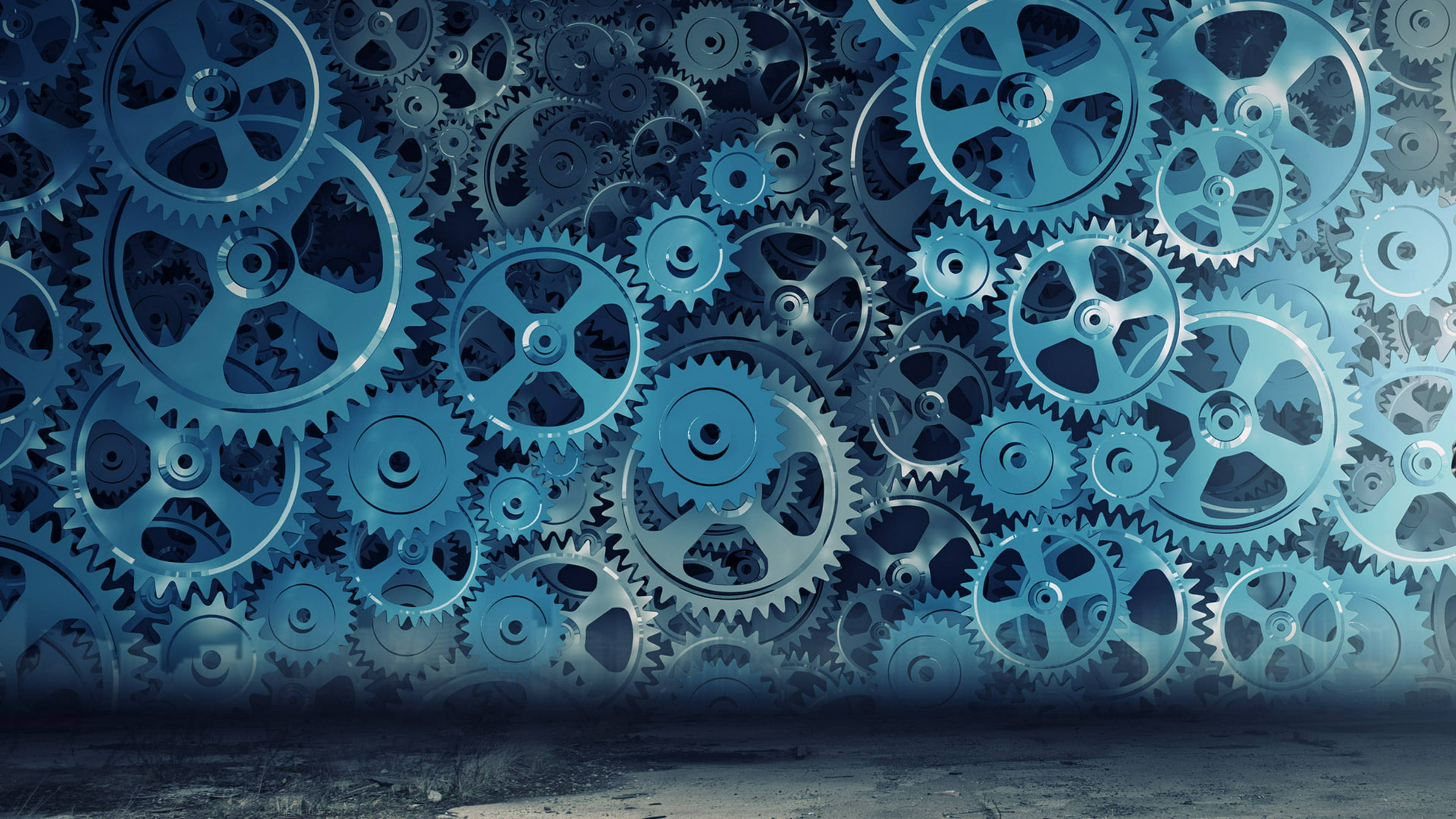 Canva 桌布 壁紙 — 一堵由相互交錯的藍色金屬齒輪組成的密集牆壁，營造出複雜的機械背景，下方是深色混凝土地板。