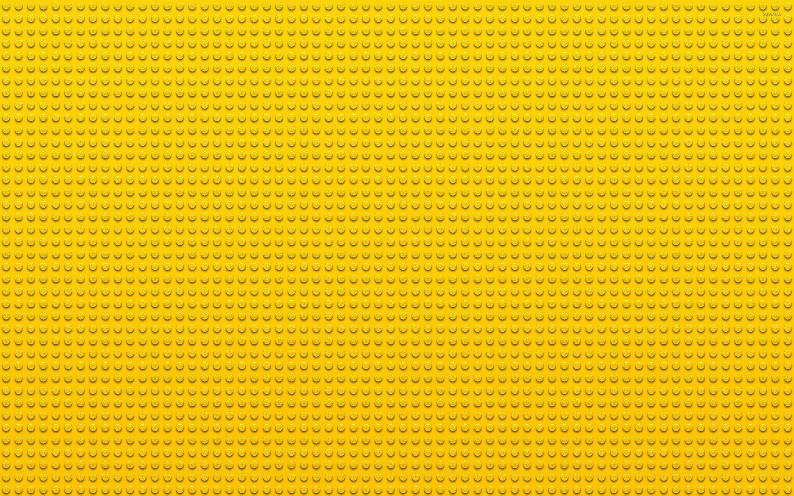 樂高 桌布 壁紙 — 一塊無縫的黃色LEGO底板，表面覆蓋均勻的圓形凸點。