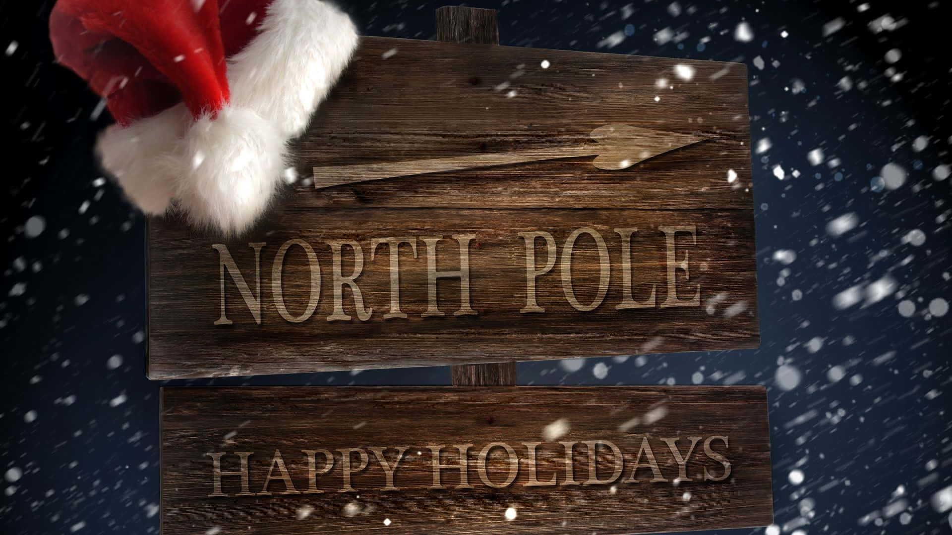 North Pole 桌布 壁紙 — 一塊鄉村風格的木牌，上面寫著 North Pole 和 Happy Holidays，頂部放著一頂聖誕帽，背景是雪夜的天空。