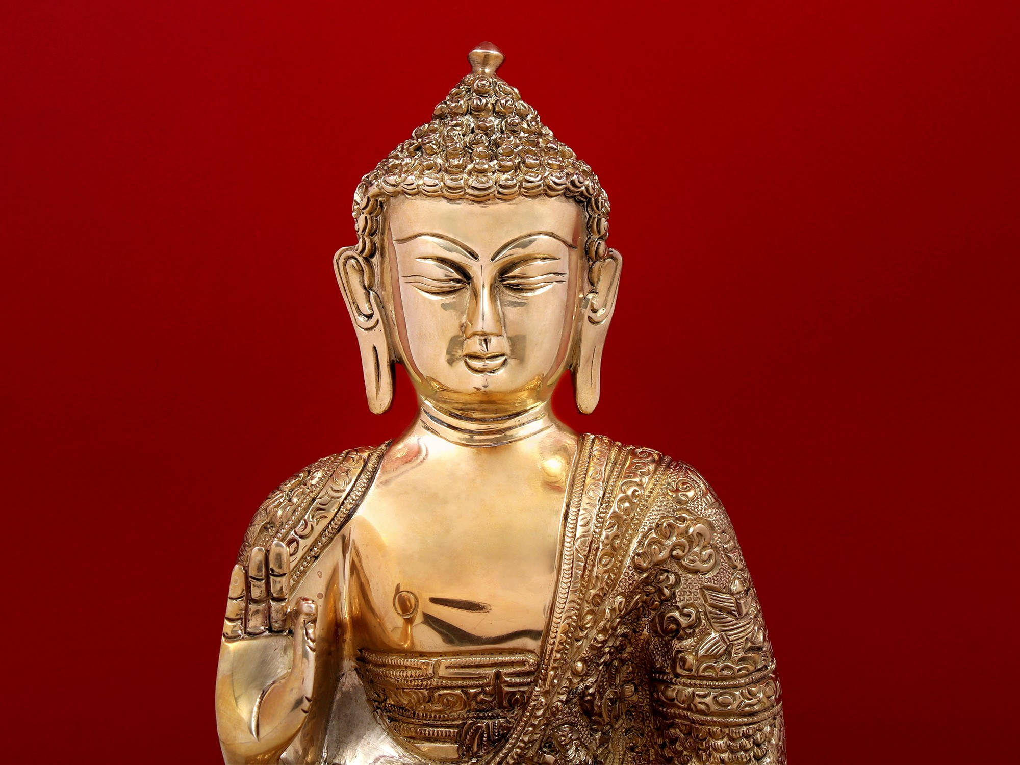 god laptop 桌布 壁紙 — 一尊金色佛像，身披精緻袈裟，雙目緊閉，在深紅色背景前靜靜佇立。
