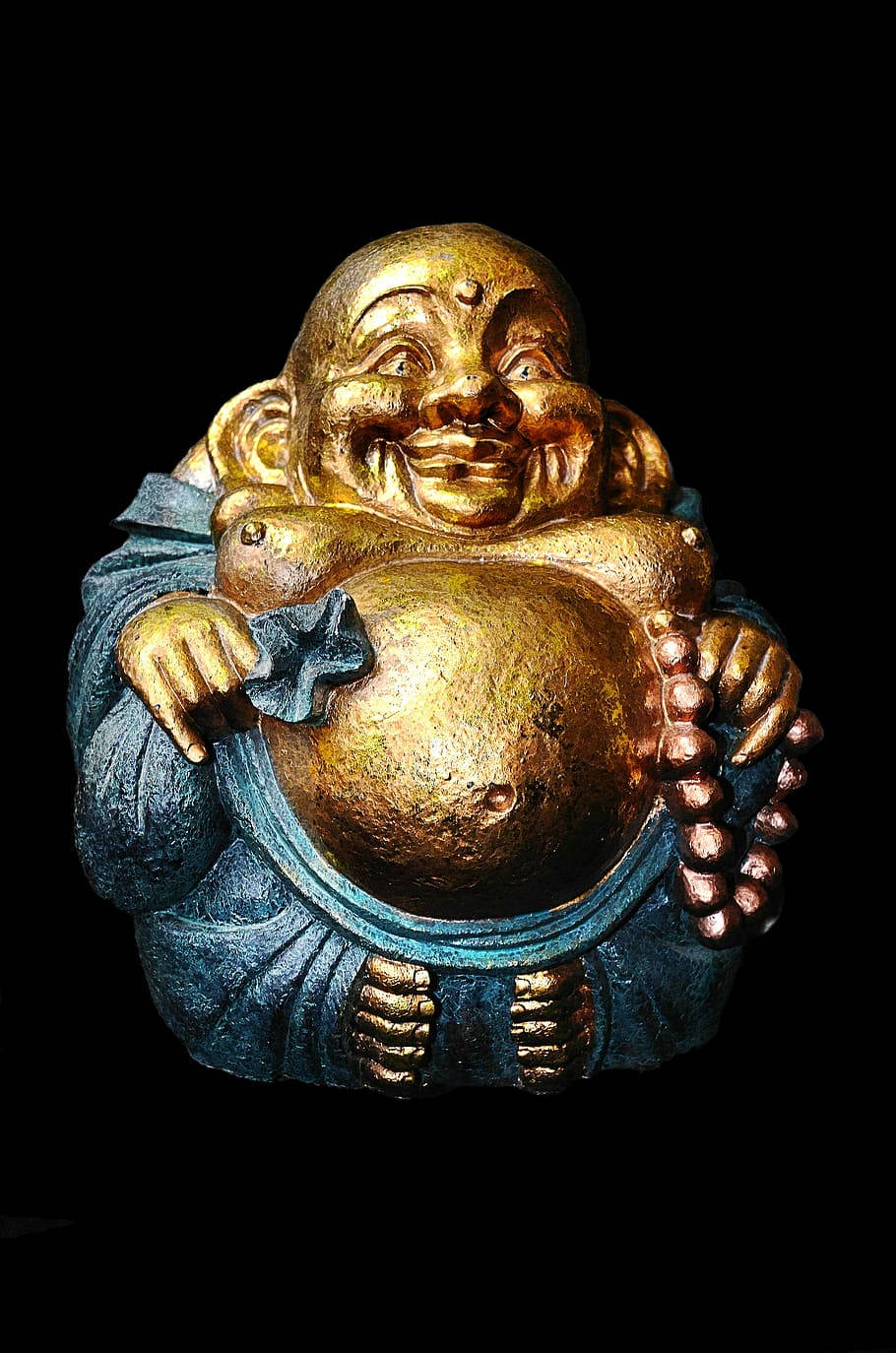 佛陀 桌布 壁紙 — 一尊閃閃發光的金色笑佛雕像，大肚子，身穿藍色長袍，在黑色背景前手持念珠。