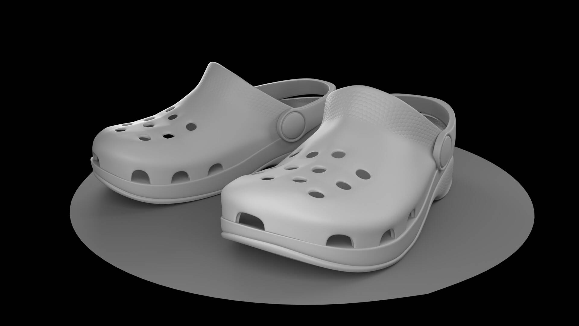 Crocs 桌布 壁紙 — 一對帶通風孔的灰色木屐涼鞋放在黑色背景的圓形平台上。