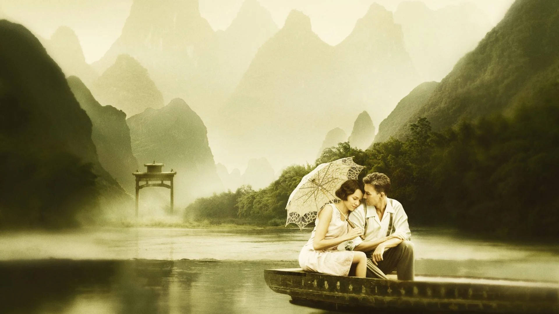 Romantic Love 桌布 壁紙 — 一對情侶在霧氣瀰漫的竹船上，於傘下分享親密時刻，漂流在寧靜的山間河谷中。