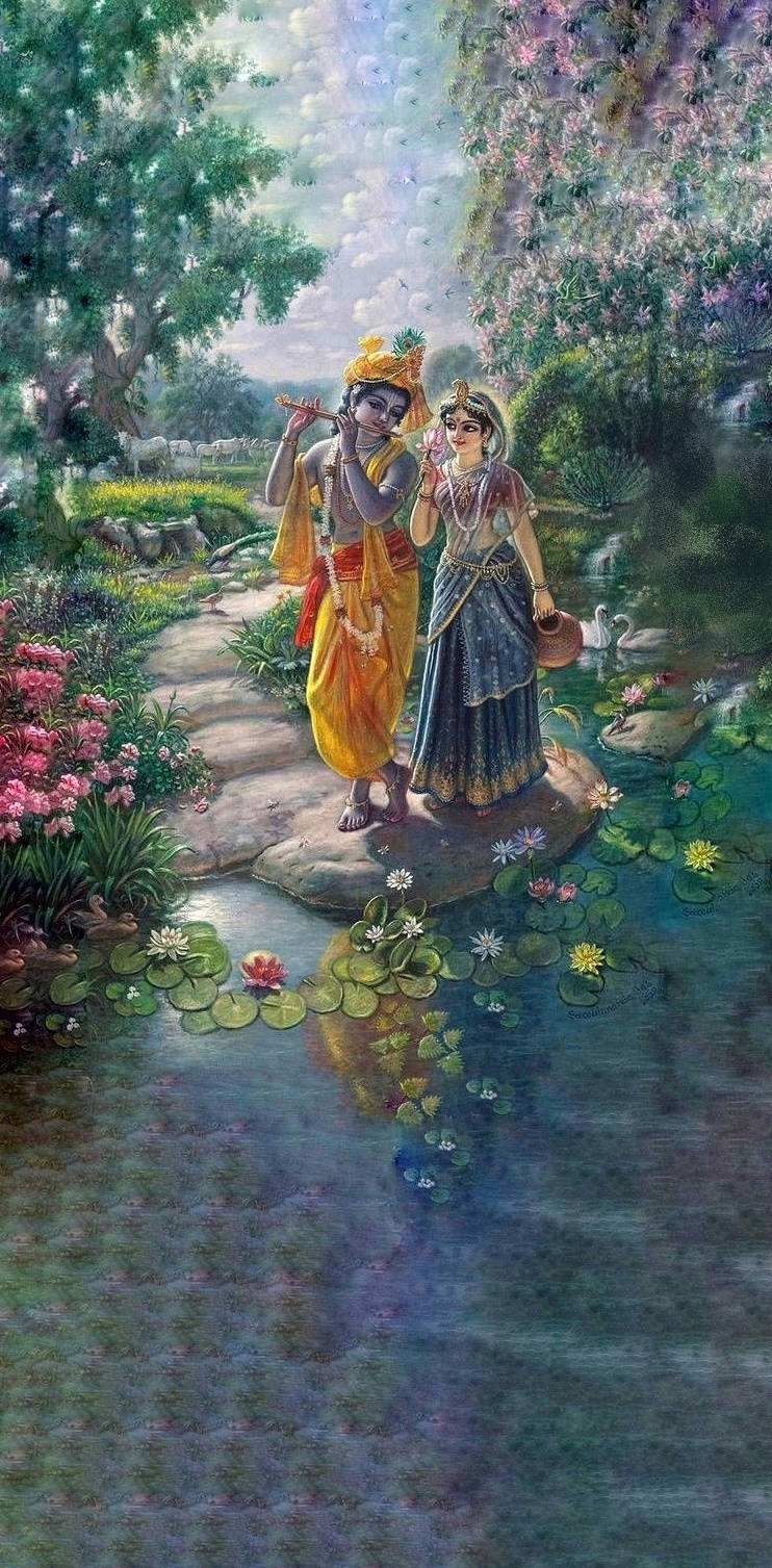 krishna iPhone 桌布 壁紙 — 一對神聖的伴侶沿著石徑漫步，旁邊是蓮花盛開的池塘，在柔和日光下的茂盛花園中。