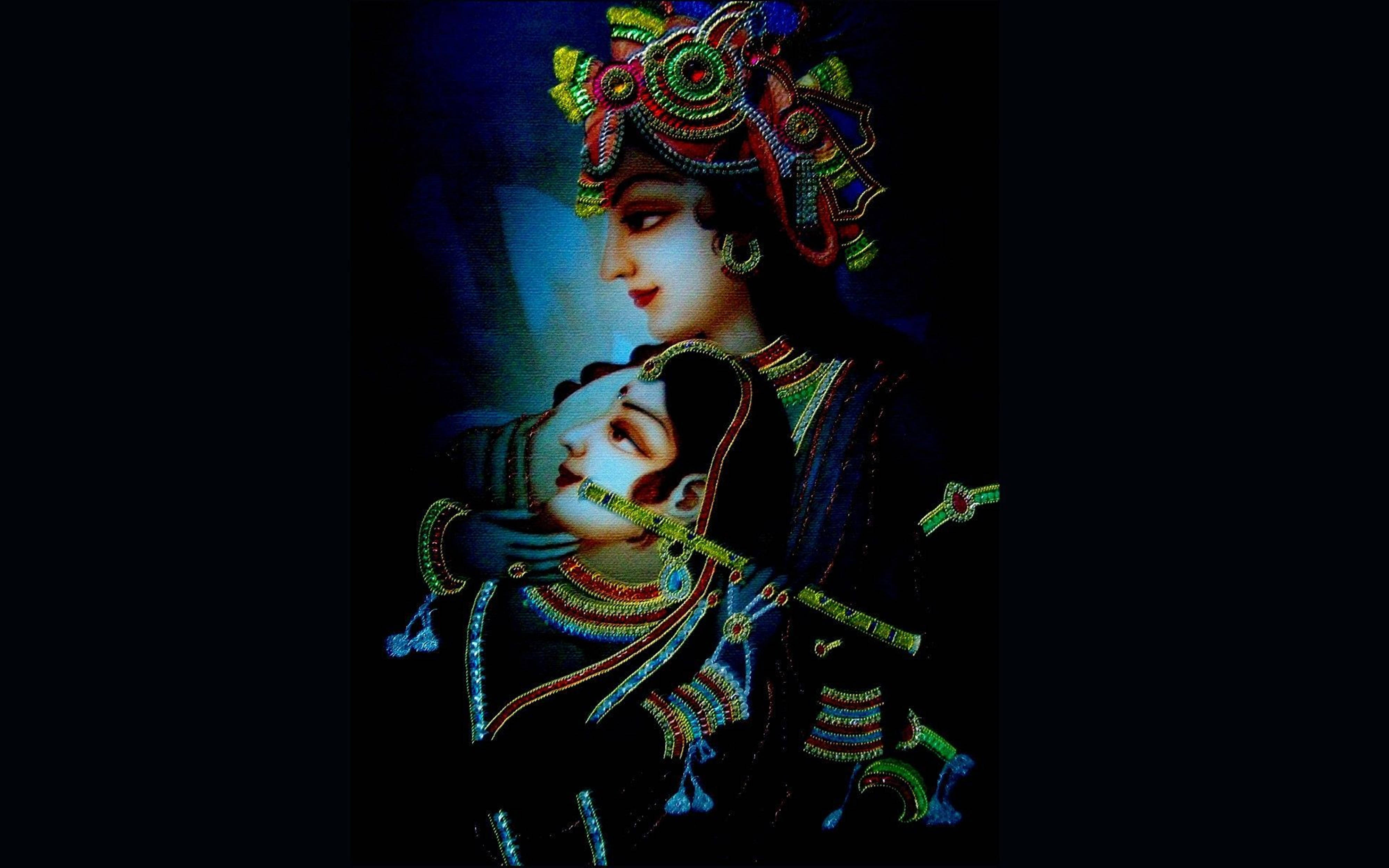 Digital 桌布 壁紙 — 一對神聖的夫婦穿著華麗的傳統服飾，在深藍色背景下擁抱，飾有精緻的珠寶和發光的裝飾。
