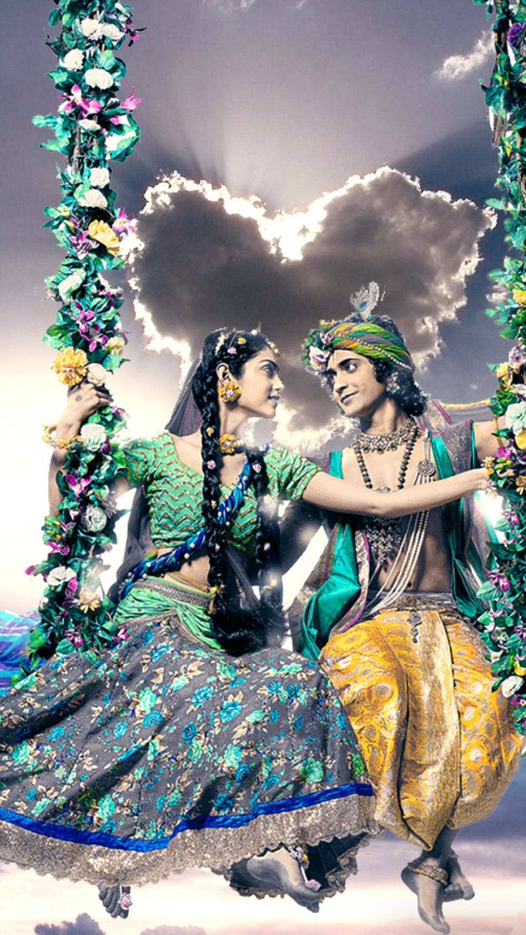 radha krishna serial 桌布 壁紙 — 一對穿著華麗傳統服飾的夫婦坐在花卉鞦韆上，背景是戲劇性的心形雲天空。