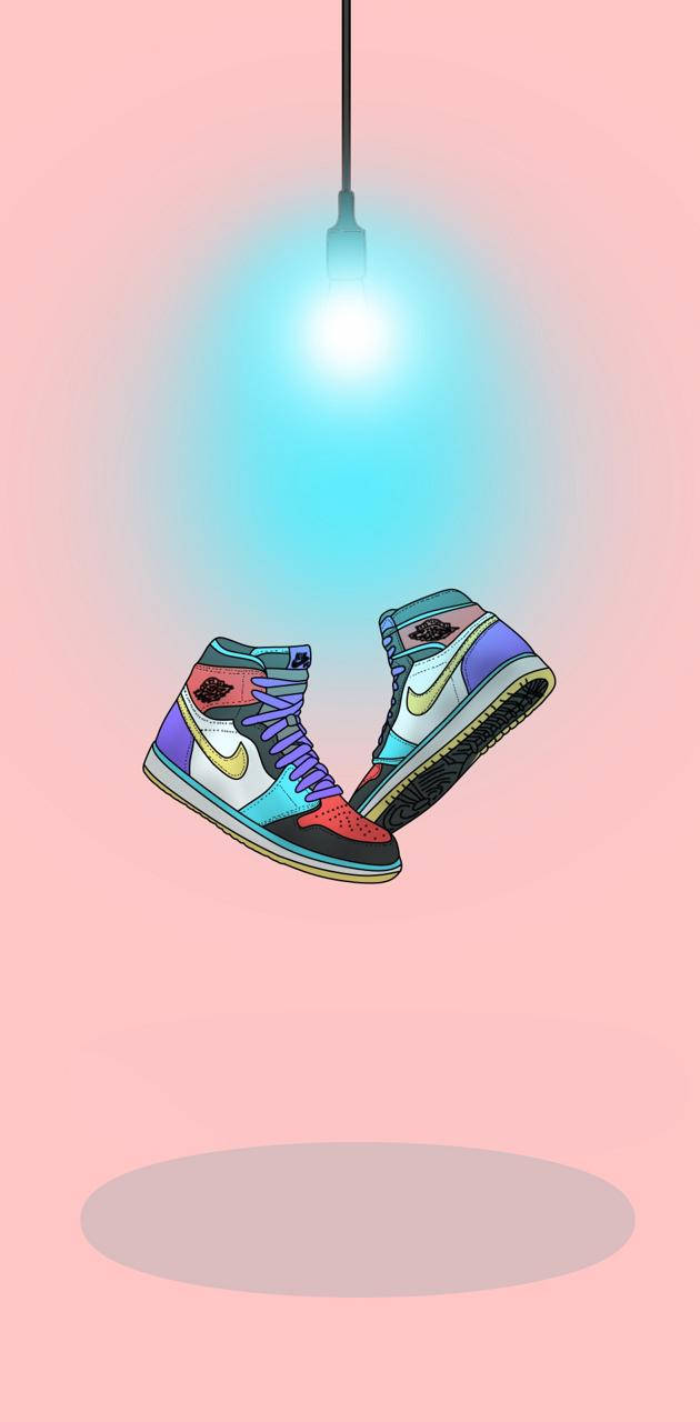 Nike Air Jordan 1 桌布 壁紙 — 一對色彩繽紛的高筒運動鞋懸掛在發光的藍色燈光下，背景是柔和的粉紅色。