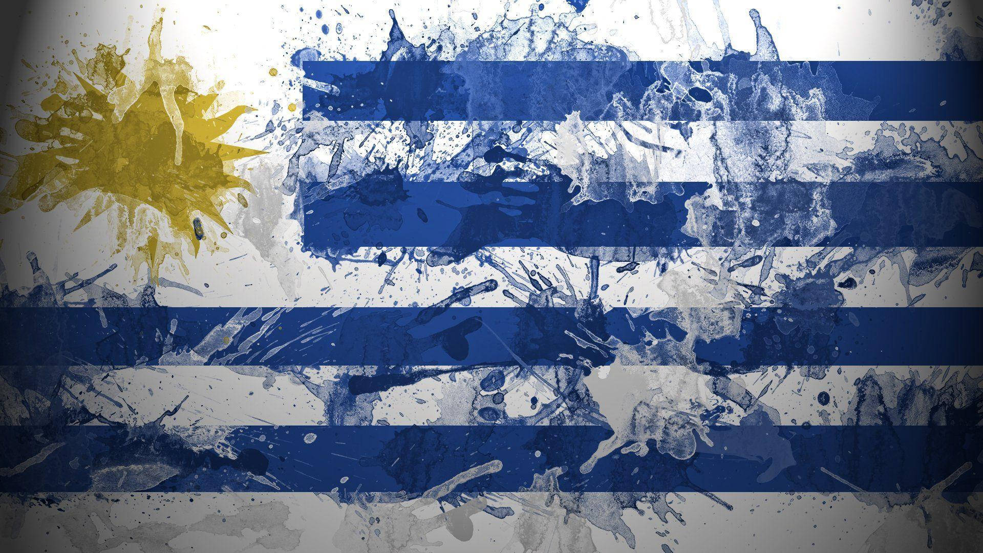 Uruguay 桌布 壁紙 — 一幅充滿動感的烏拉圭國旗潑墨畫，帶有醒目的藍白條紋和充滿活力的黃色太陽光芒。