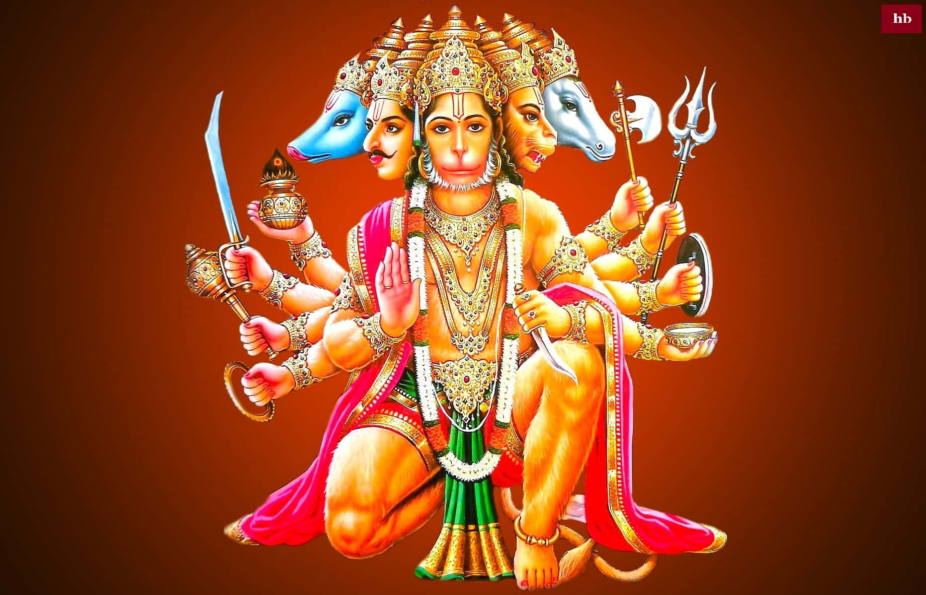 Hanuman 桌布 壁紙 — 一幅充滿活力的哈努曼勳爵插圖，有多隻手臂和頭顱，飾有黃金珠寶和紅綠色服裝，手持武器和符號。
