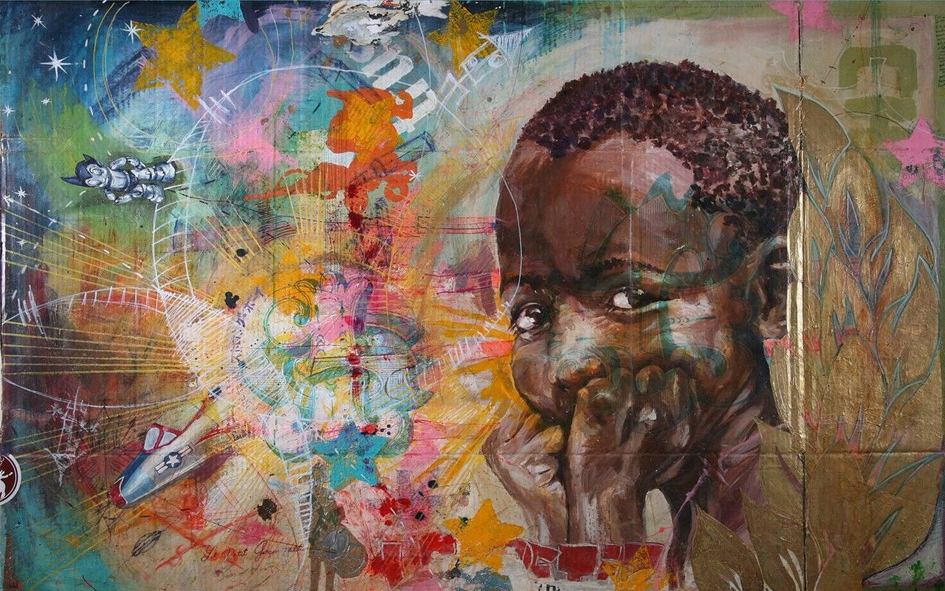 非洲藝術 桌布 壁紙 — 一幅充滿活力的抽象畫，描繪一位年輕黑人男孩手托下巴，周圍環繞著星星、火箭和色彩繽紛的混亂筆觸。