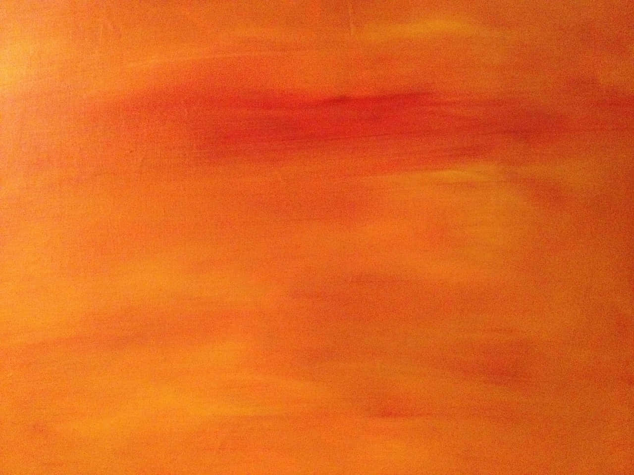 Orange Gradient 桌布 壁紙 — 一幅充滿活力的抽象畫，混合了橙色和紅色色調，柔和的筆觸營造出溫暖發光的效果。