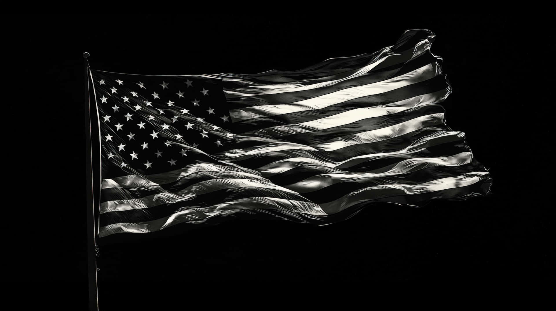 A high-contrast black and white depiction of the American flag waving in the wind 壁紙 — 一幅單色美國國旗在純黑背景上動態飄揚，戲劇性的燈光突顯其紋理布料。