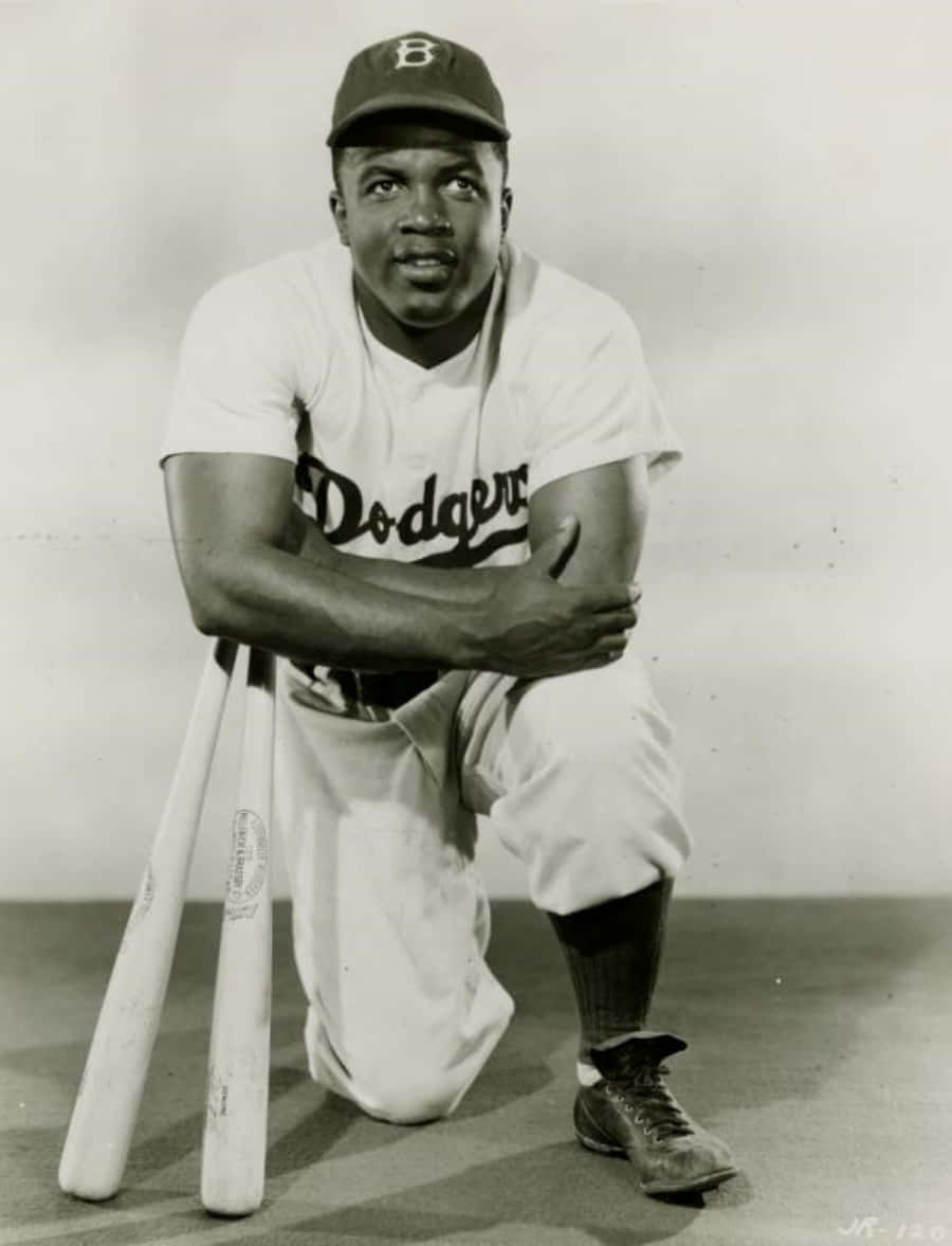 Jackie Robinson 桌布 壁紙 — 一幅復古黑白肖像，描繪一名身穿道奇隊制服、跪著手持球棒的棒球選手。